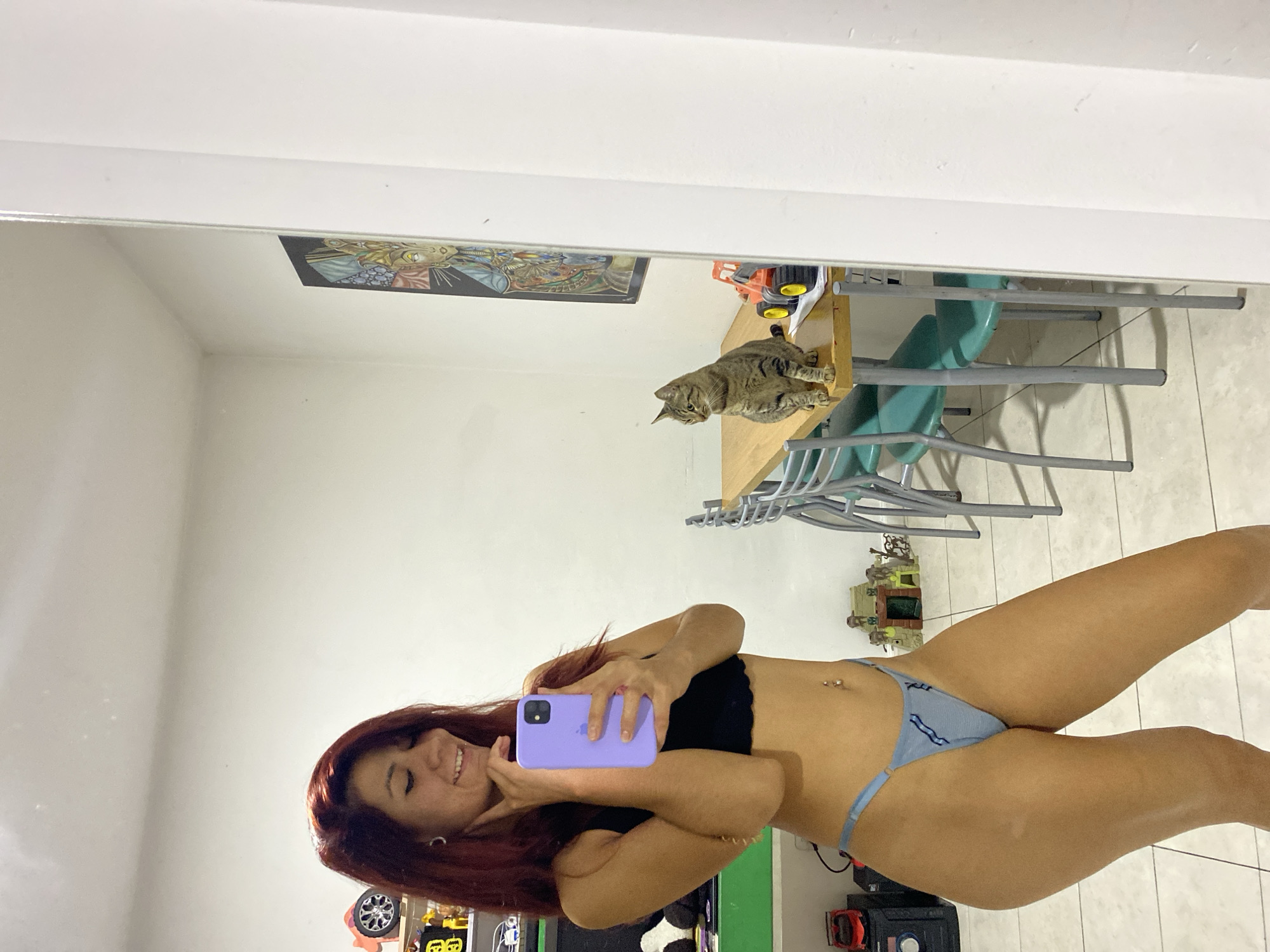 Woman takes mirror selfies at home in Wilde, Argentina