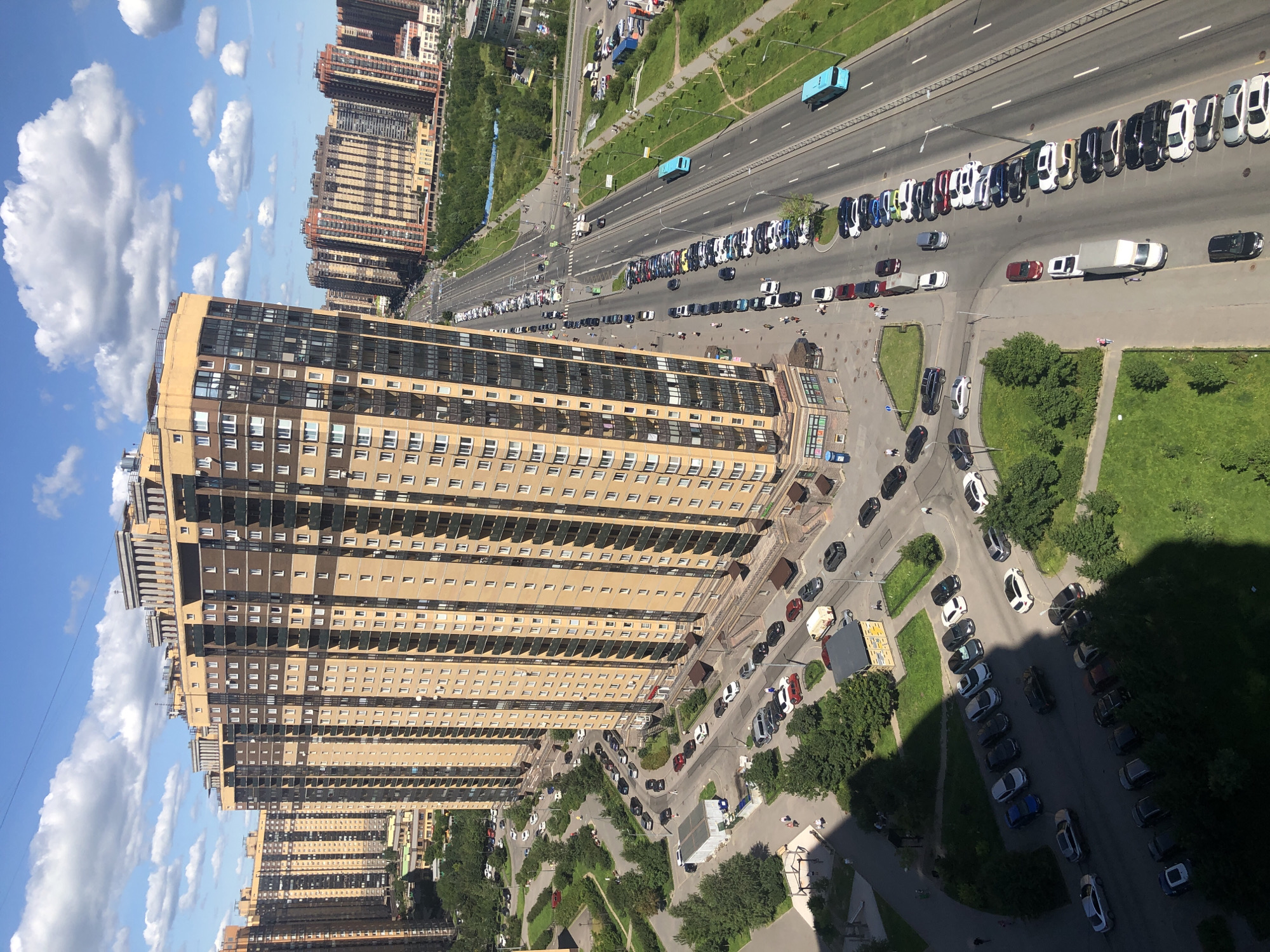 Drone pass over a mixed-use urban district on a sunny day