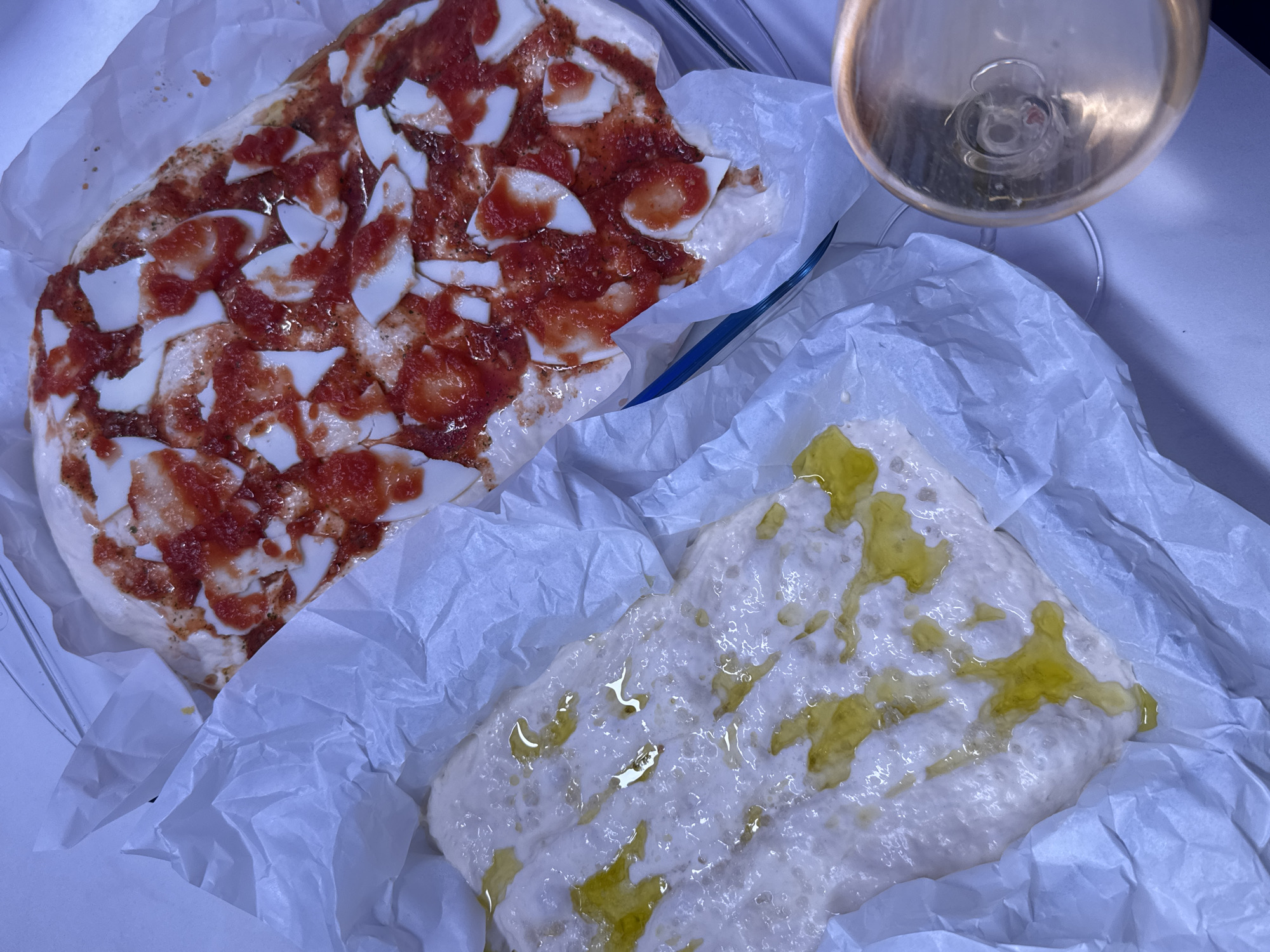 Woman prepares homemade pizza in Ariel kitchen afternoon