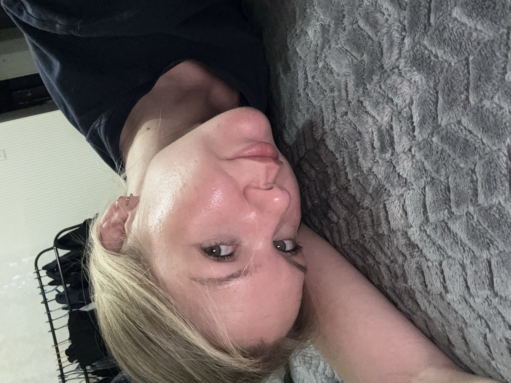 Woman takes selfies while resting with cat in Perm