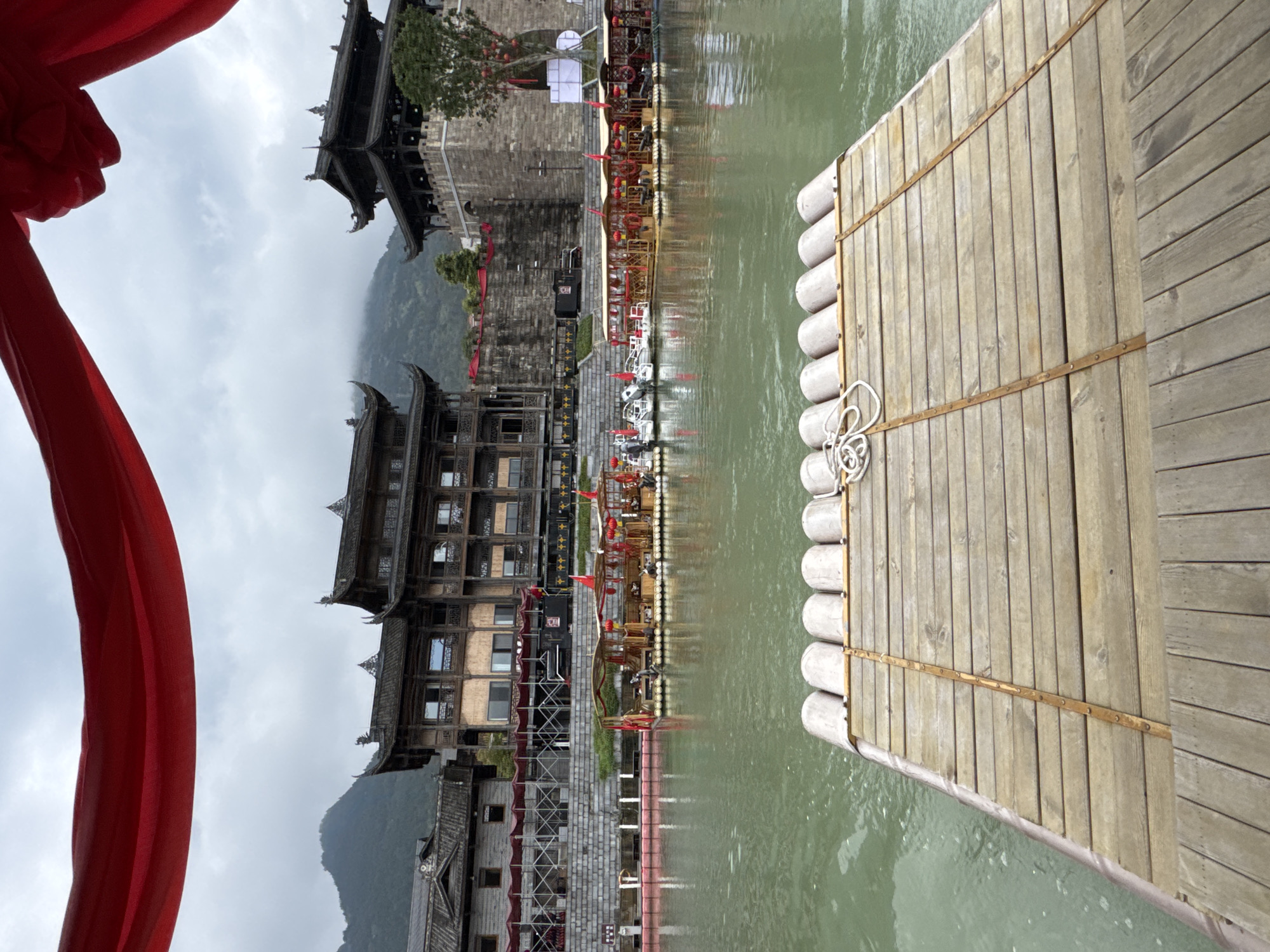 Tourist river rafting experience in traditional Chinese setting