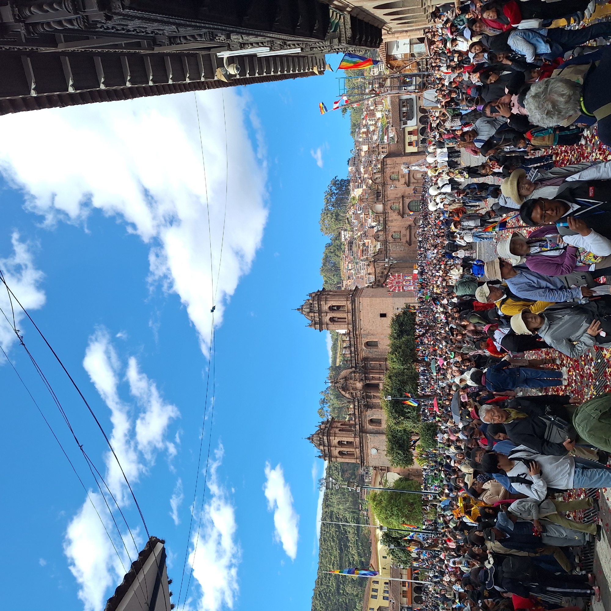 Festive crowd dances in historic Cuzco square