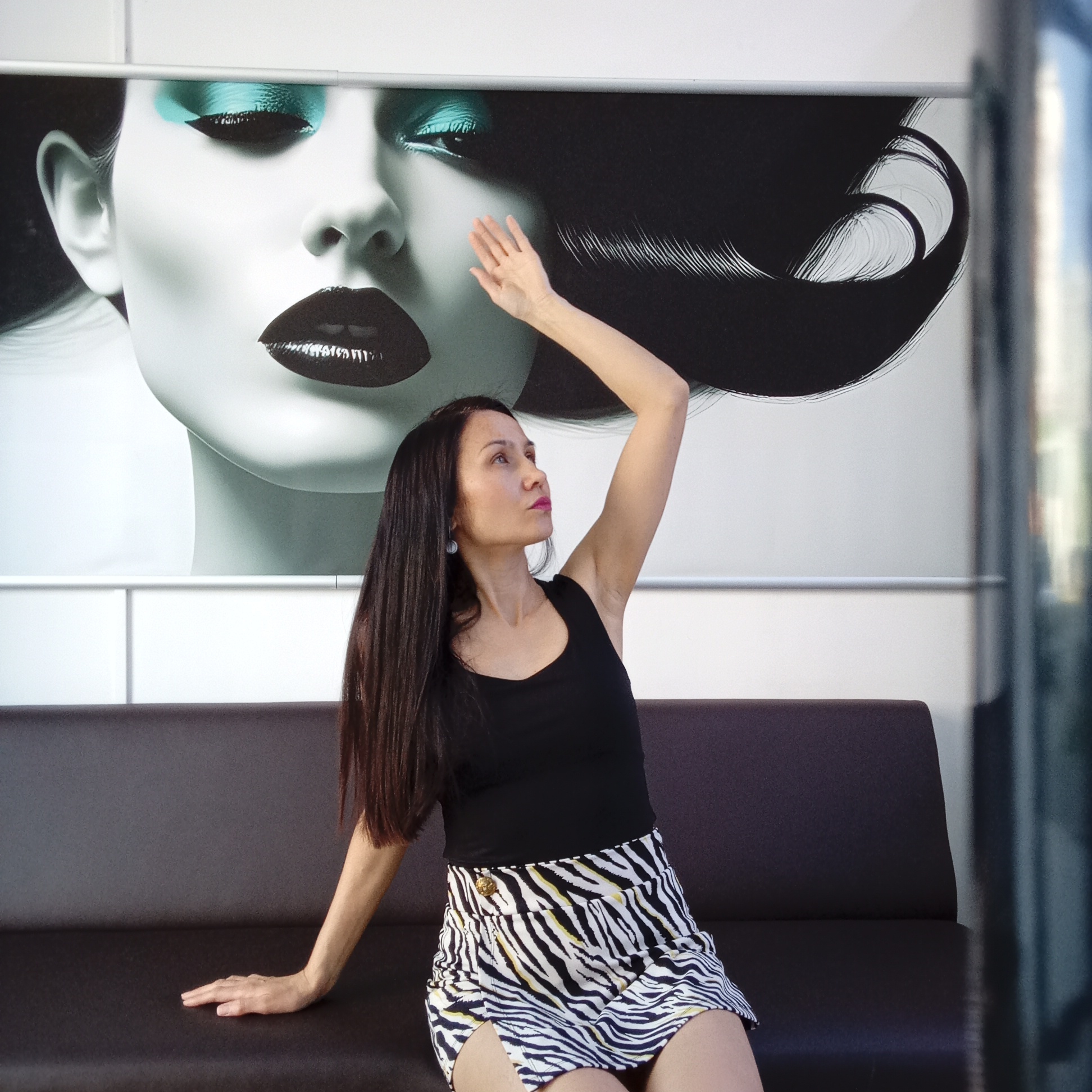 Woman in zebra-print skirt sits on sofa in Izhevsk