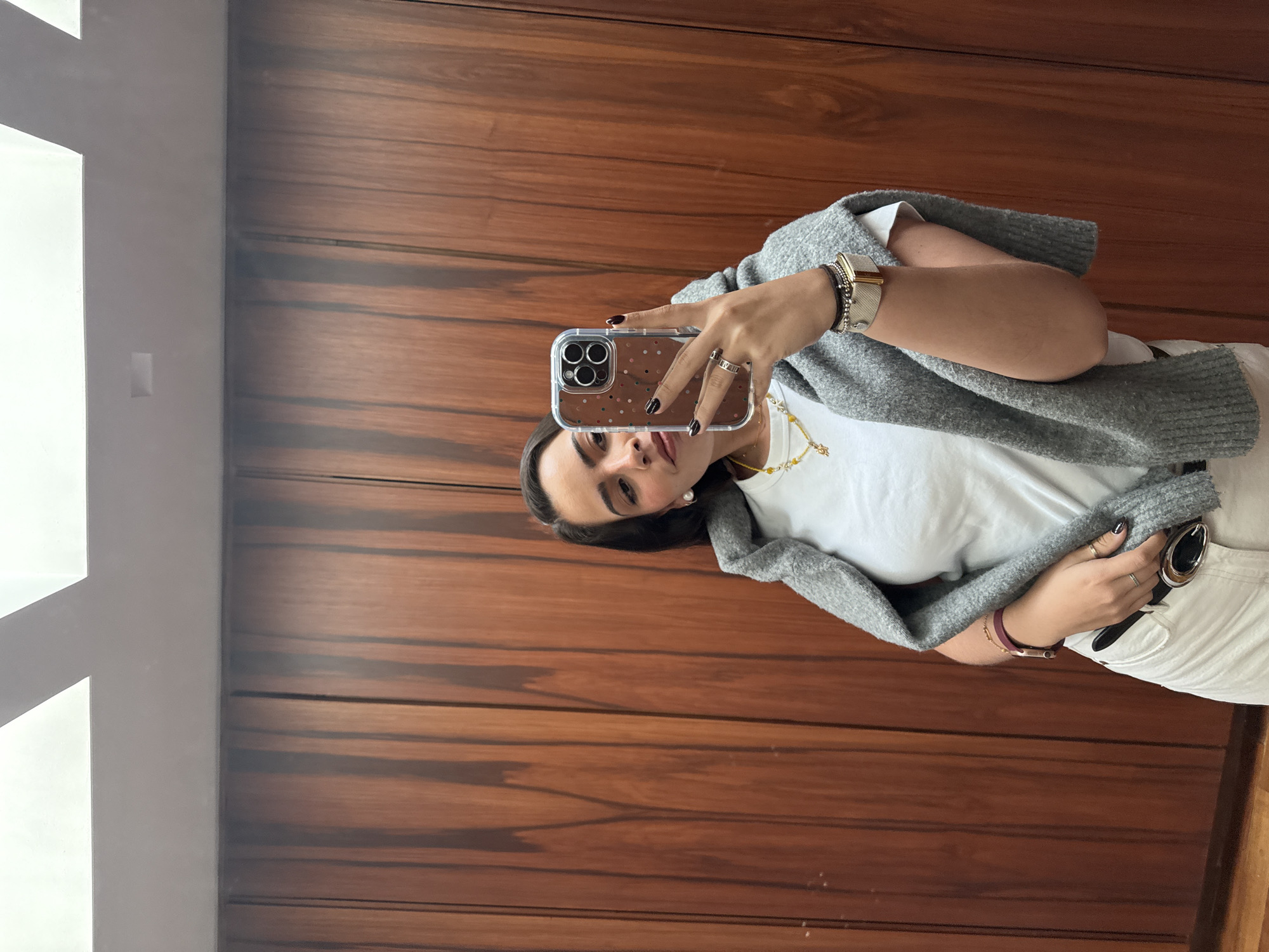 Woman poses for photos with laptop on marble stairs