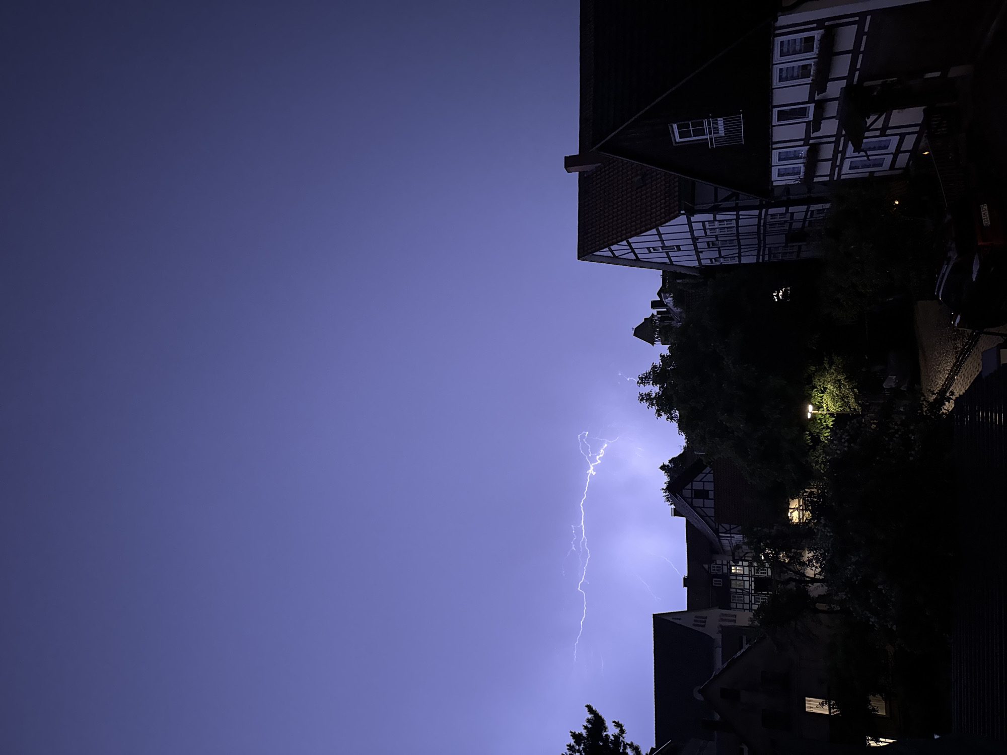 Thunderstorm lights up a German town on a summer night