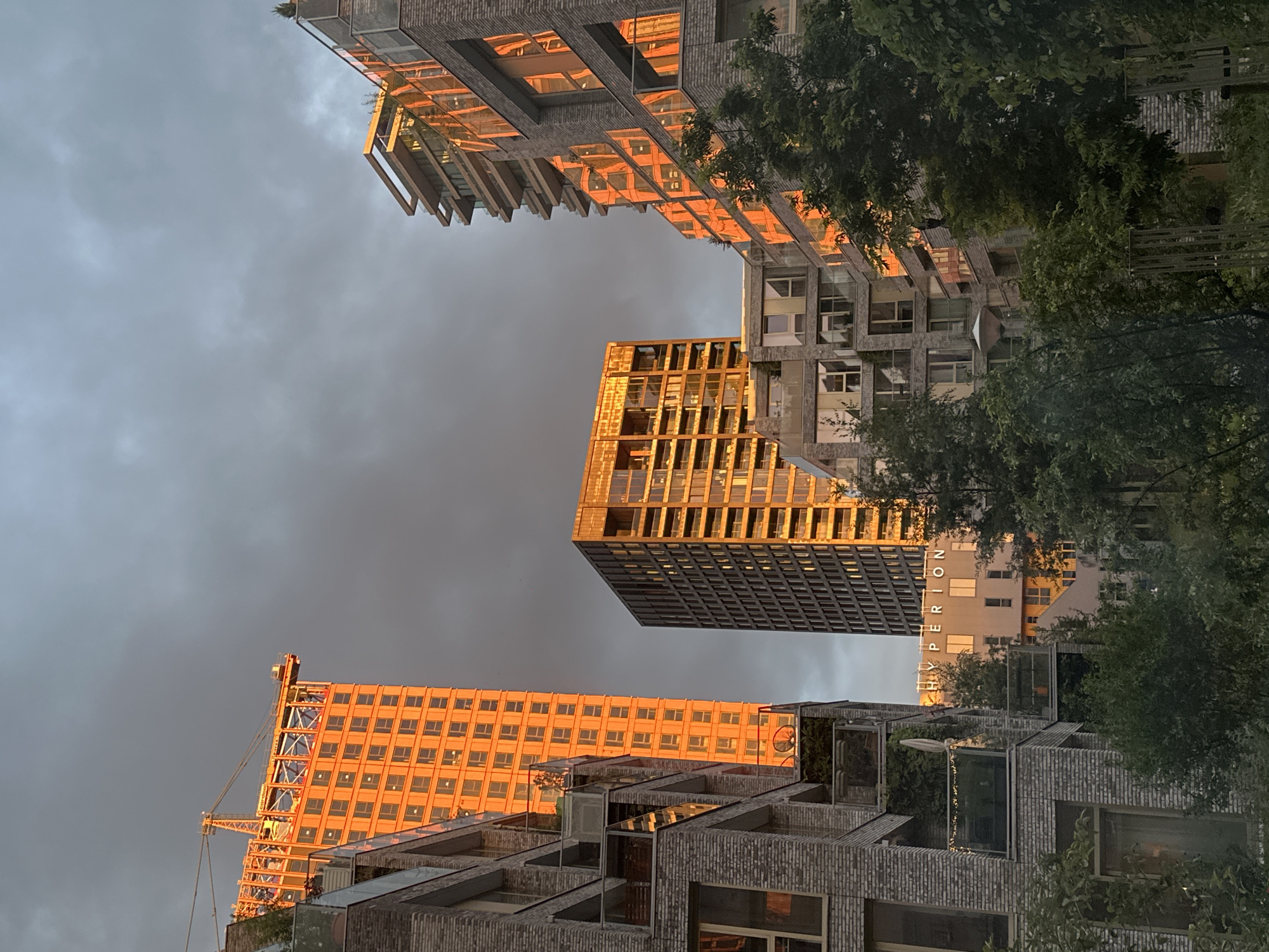 Amsterdam sunset illuminates modern buildings during evening documentation session