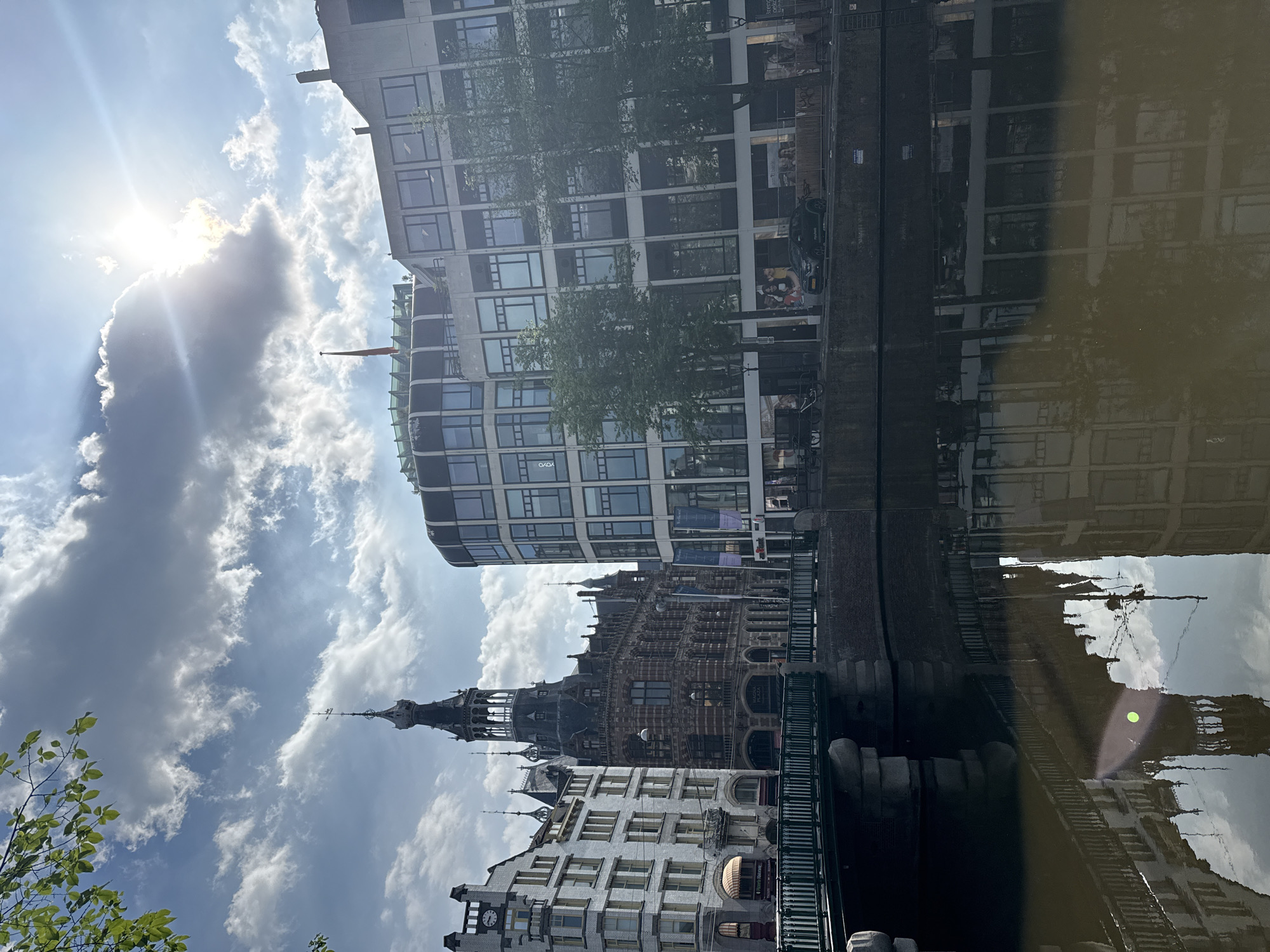 Amsterdam canal reflects mixed architecture in morning documentation
