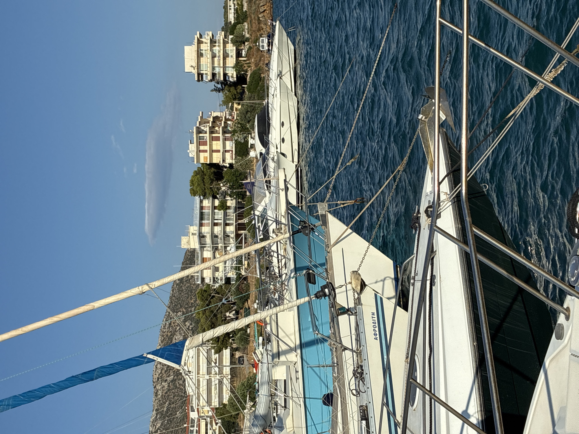 Quiet morning at Limenas Markopoulou harbor, boats moored in calm water