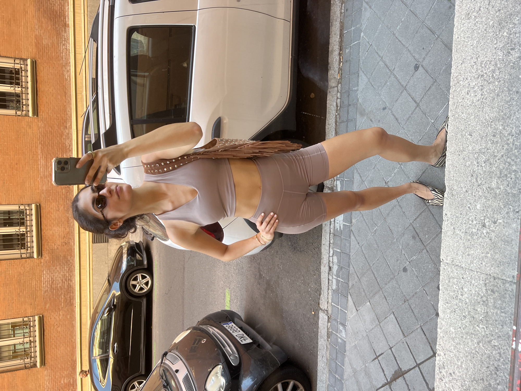 Woman poses for selfie on Madrid street