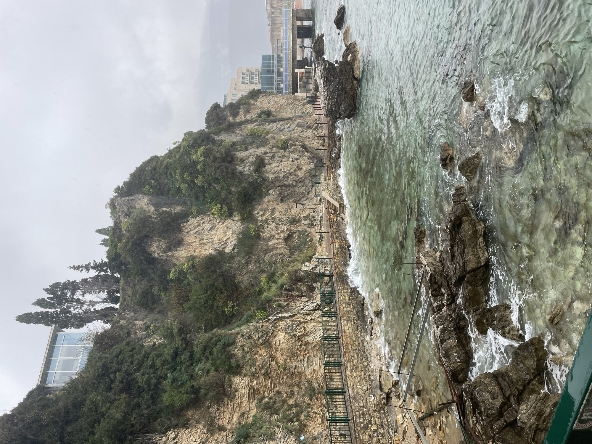 Tourist explores Budva's coastal landmarks during overcast afternoon