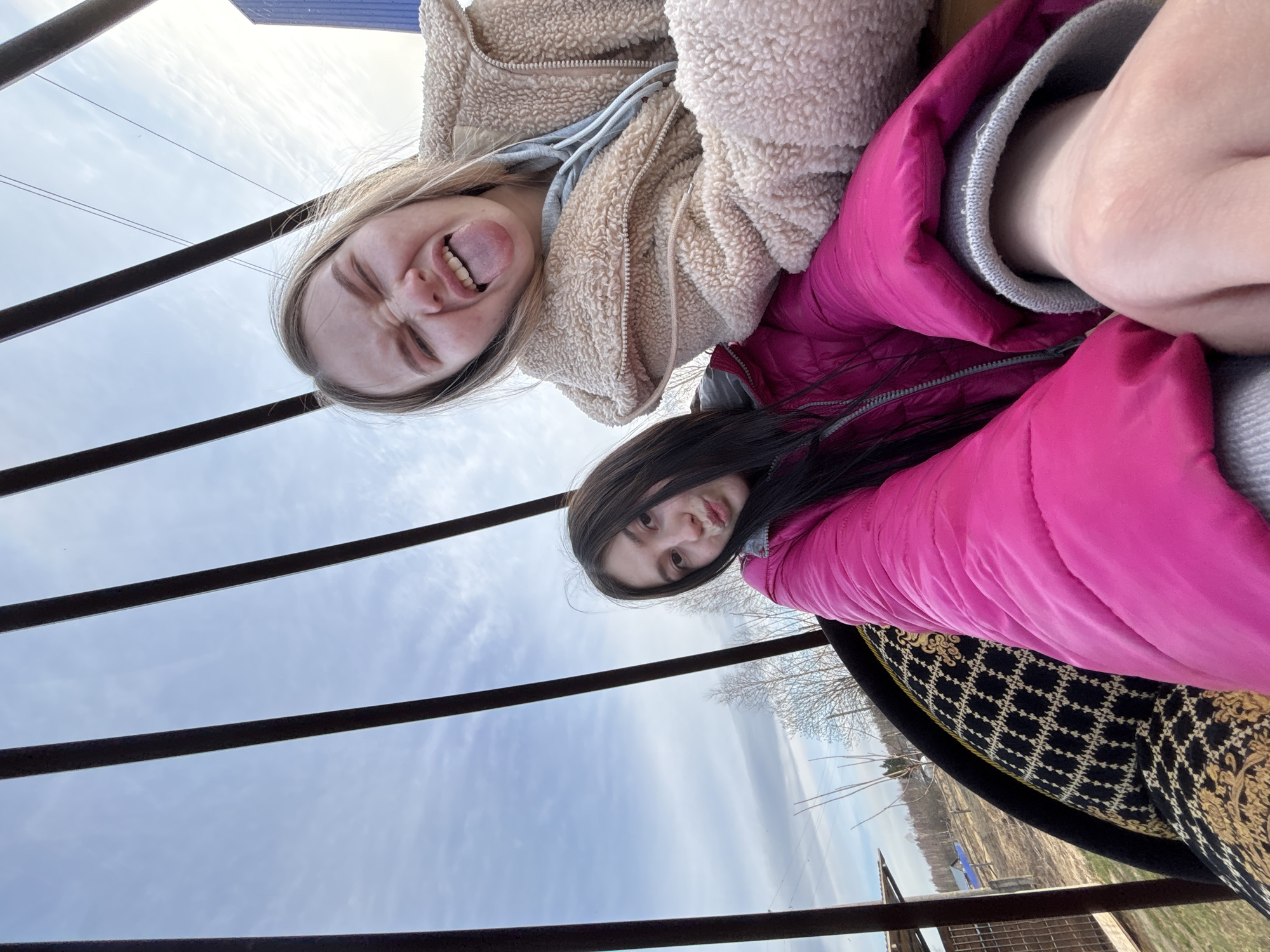 Young women take playful selfies outdoors in Russia
