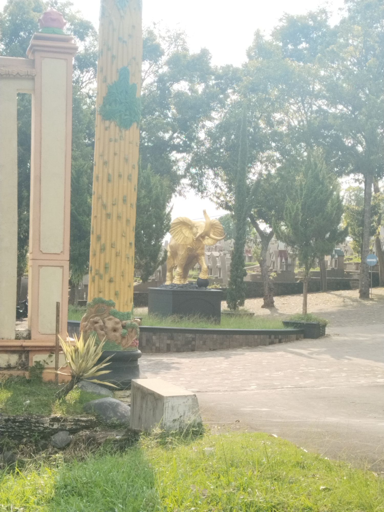 Golden elephant statue and ornate gate documented in Indonesia