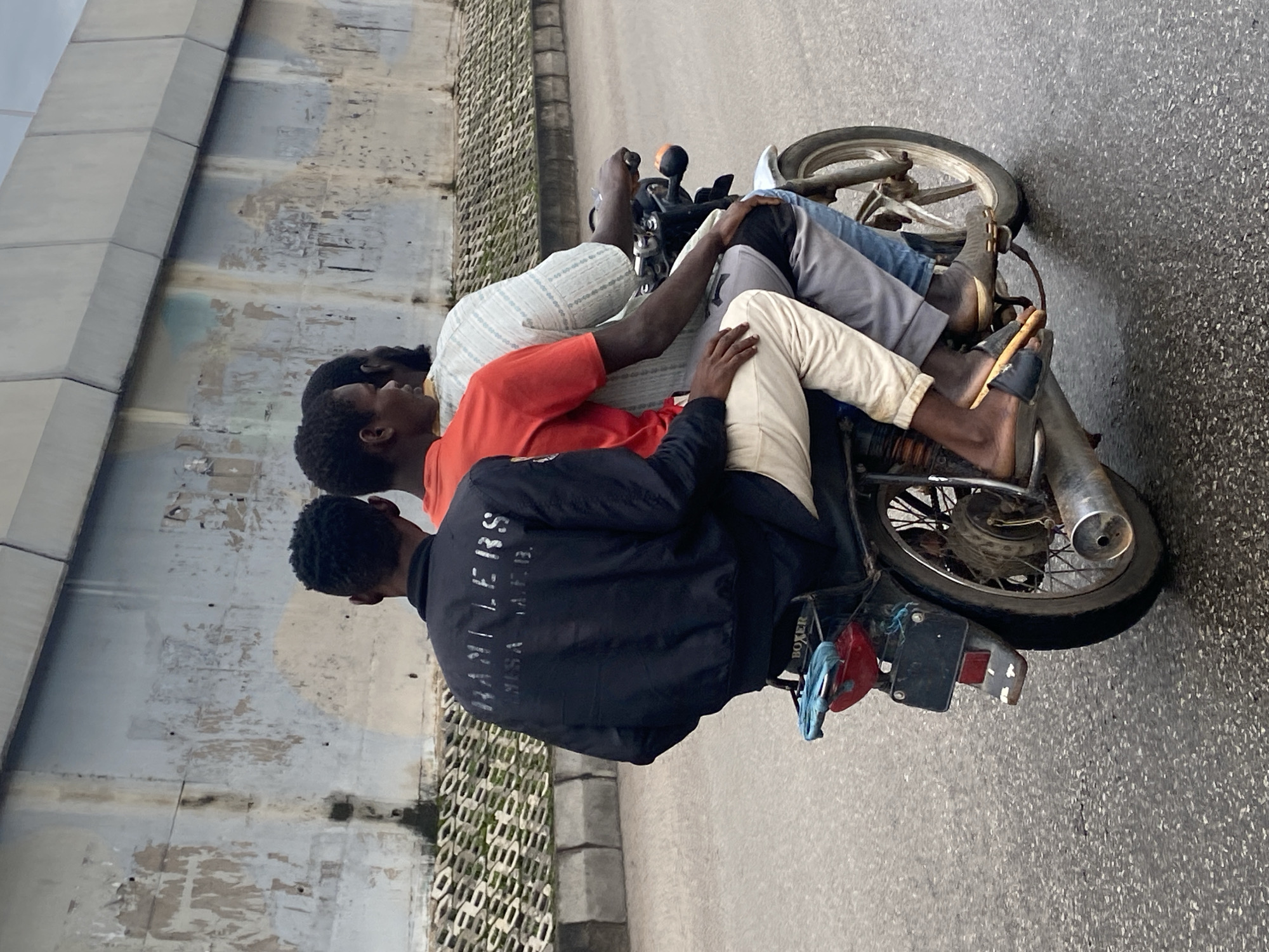 Wet morning traffic moving through the streets of Jos