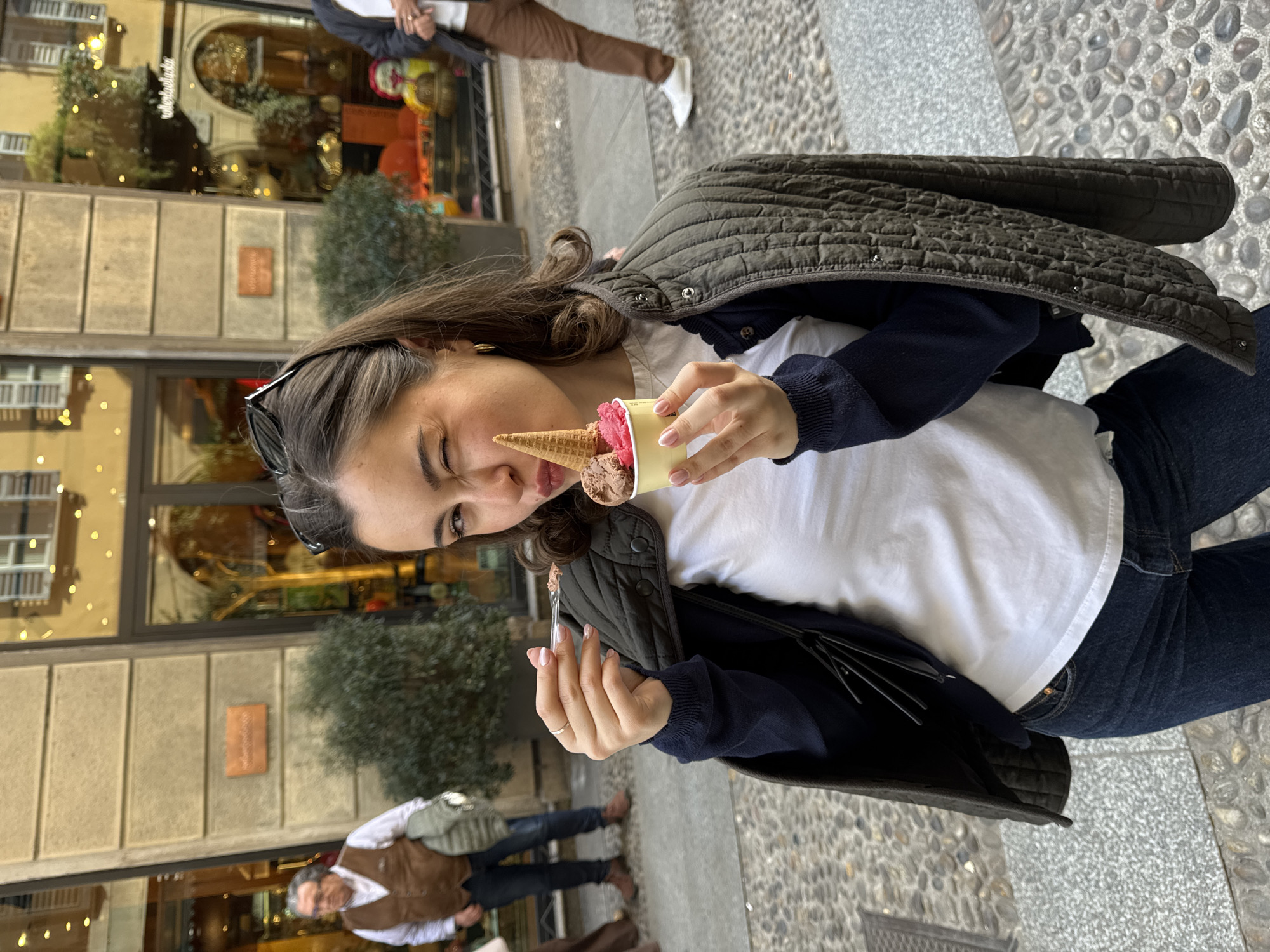 Woman photographed outside chocolate shop in Milan street scene