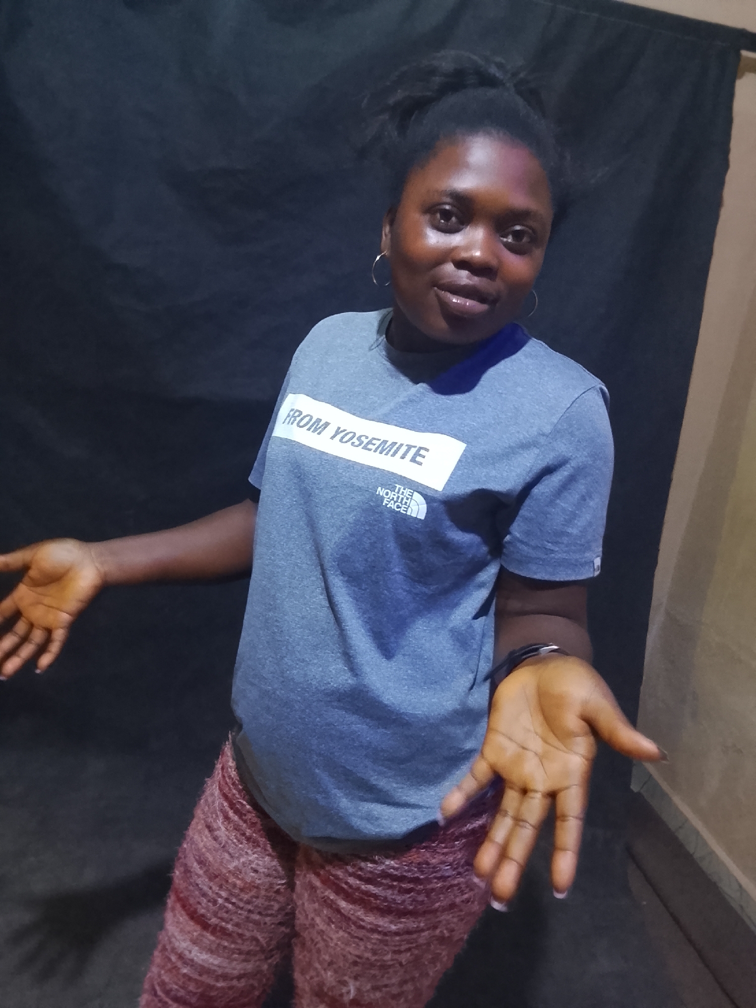 Woman poses for photos in North Face shirt