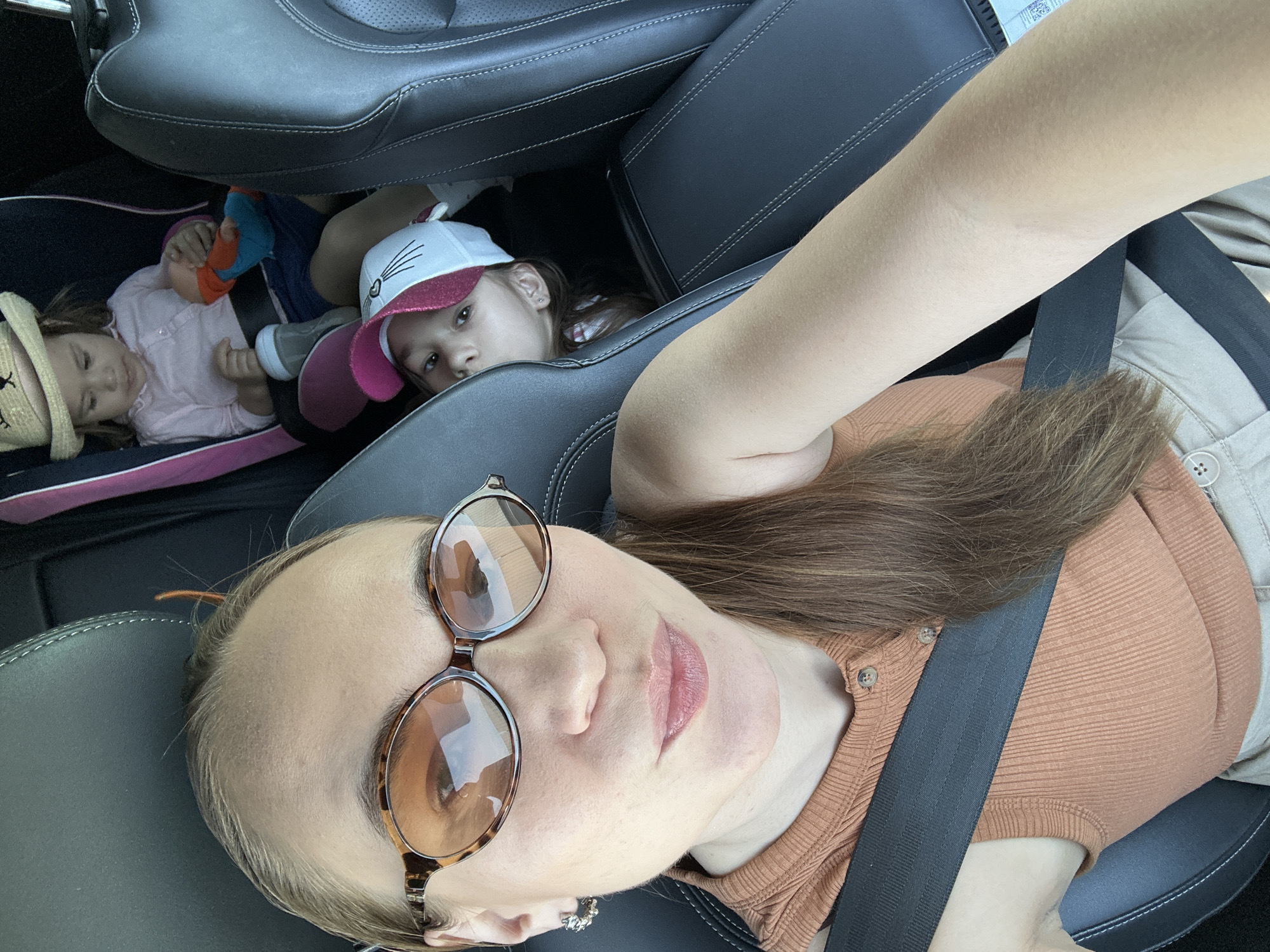 Woman takes car selfies with children in Kharnavy, Russia