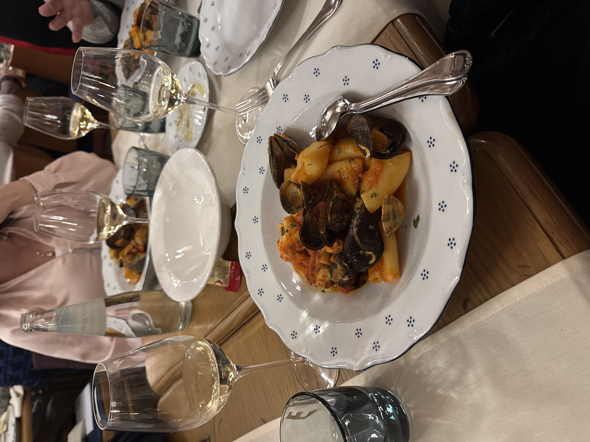 Seafood pasta dinner documented in Milan restaurant setting