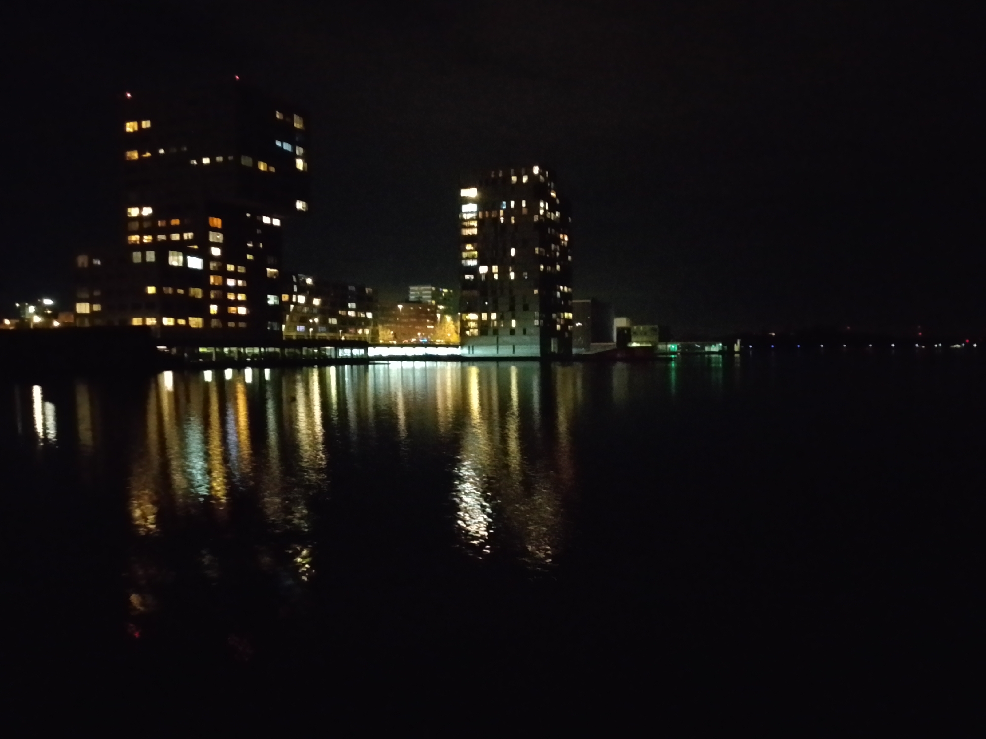 Nighttime building reflections captured in Almere waterway