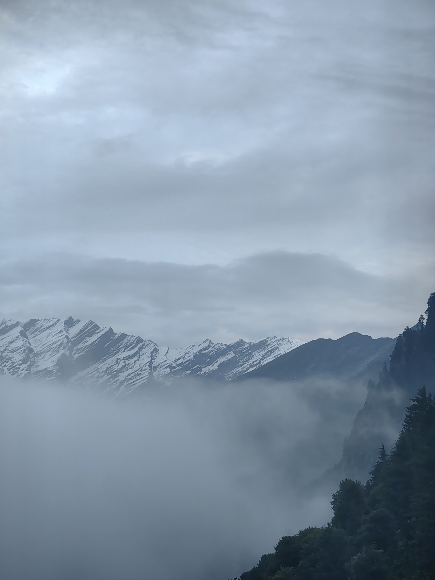 Foggy Himalayan peaks and hillside town, Vashisht