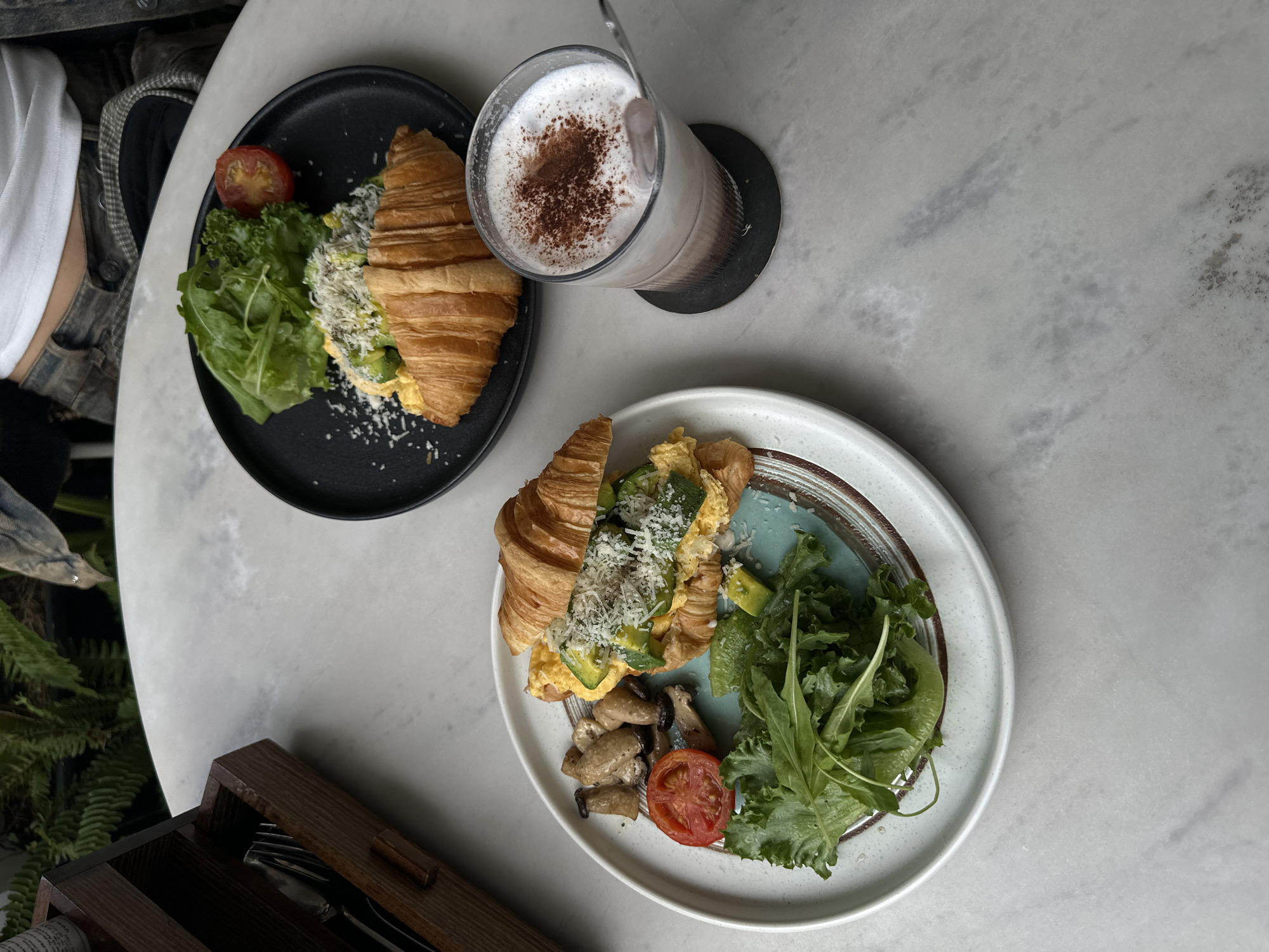 Croissant breakfast spread getting photographed at a Da Lat café