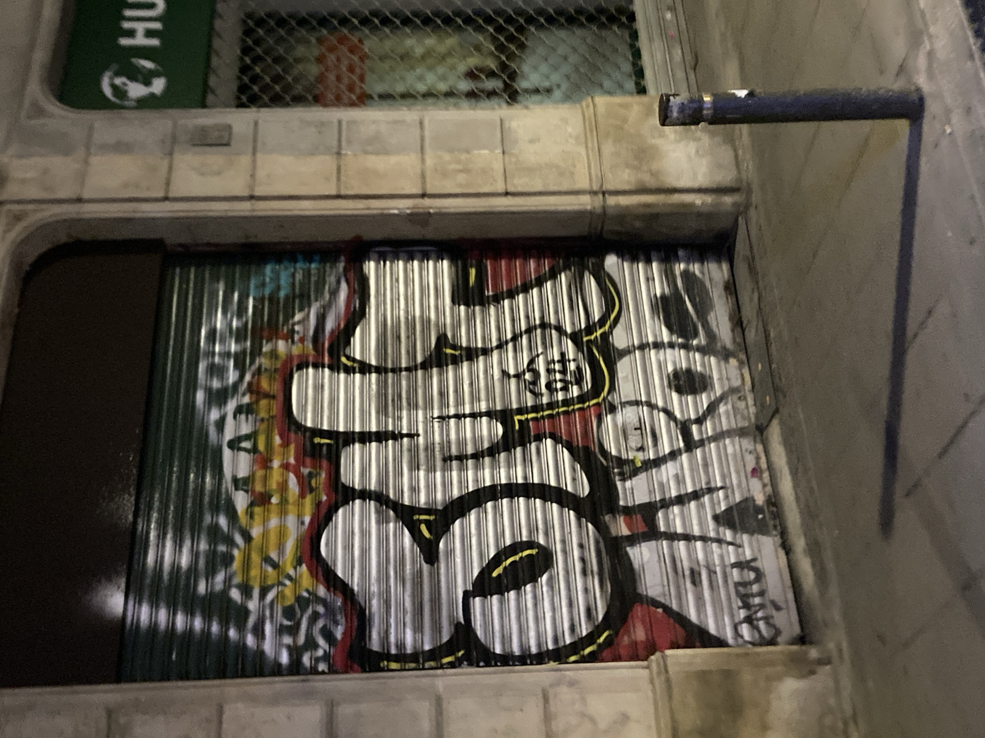 Barcelona night: graffiti shutters and a bar crowd watching football