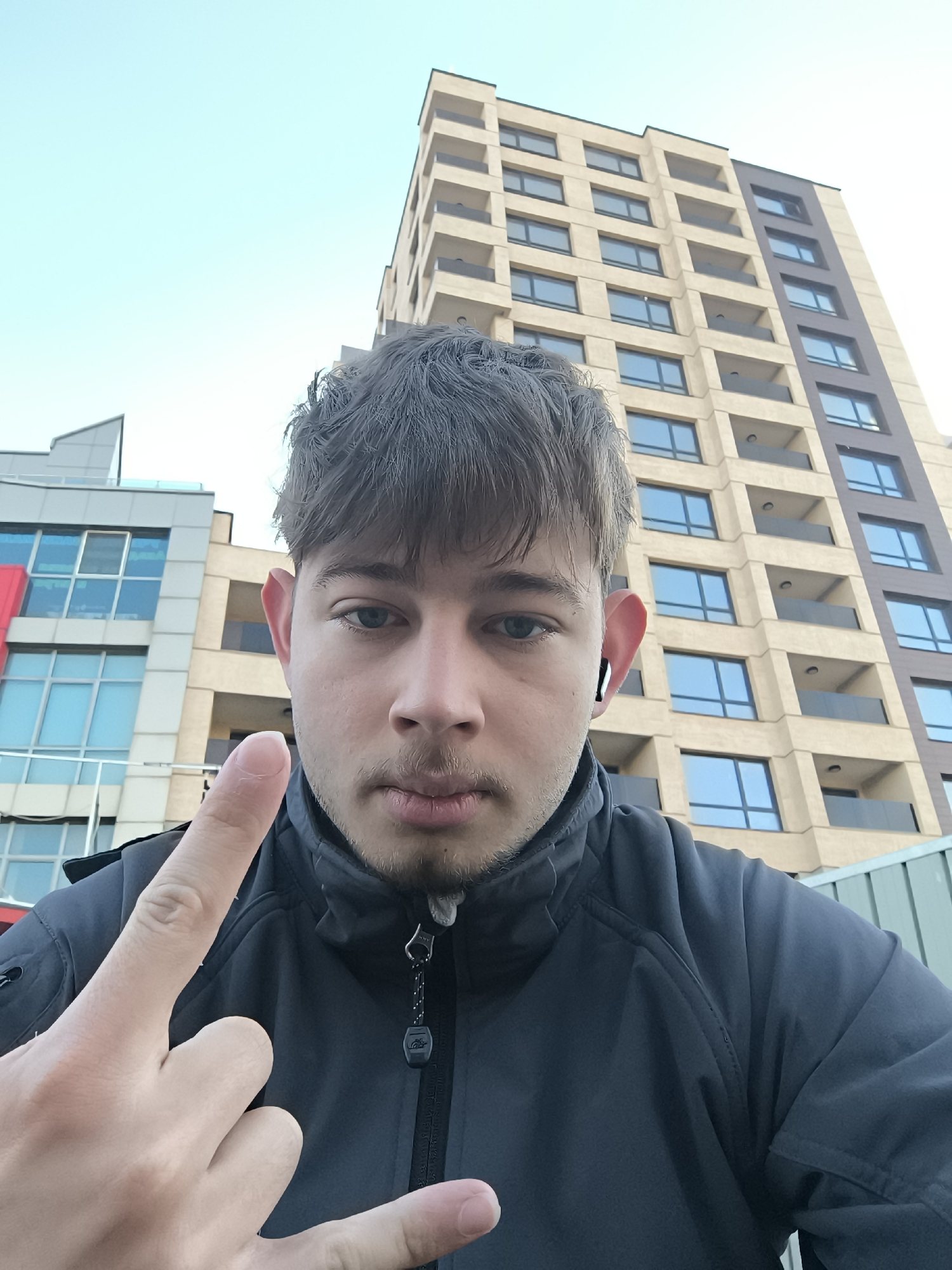 Young man photographed taking selfies in Sofia early morning