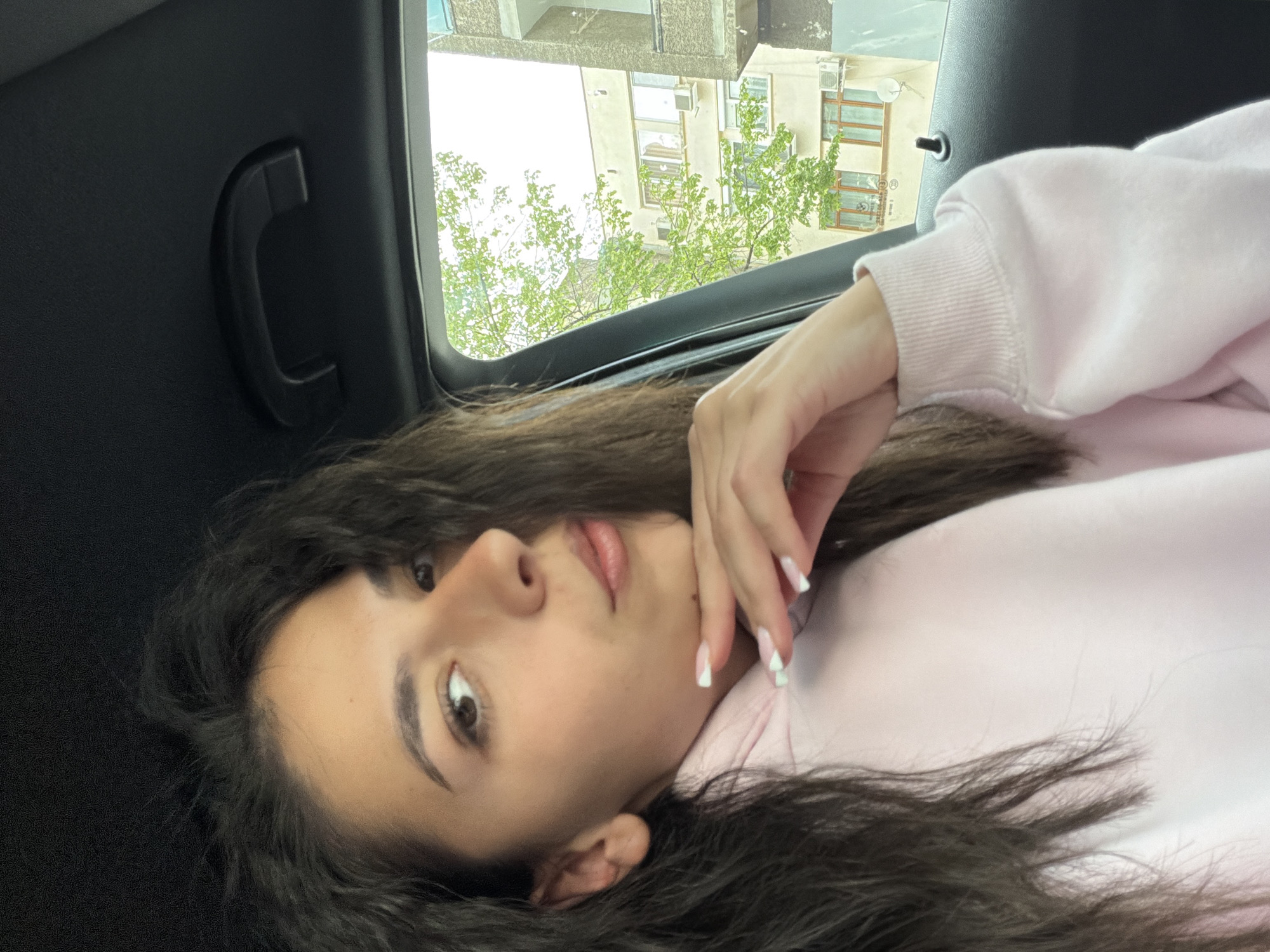Woman rests in car backseat in Gabrovo, Bulgaria