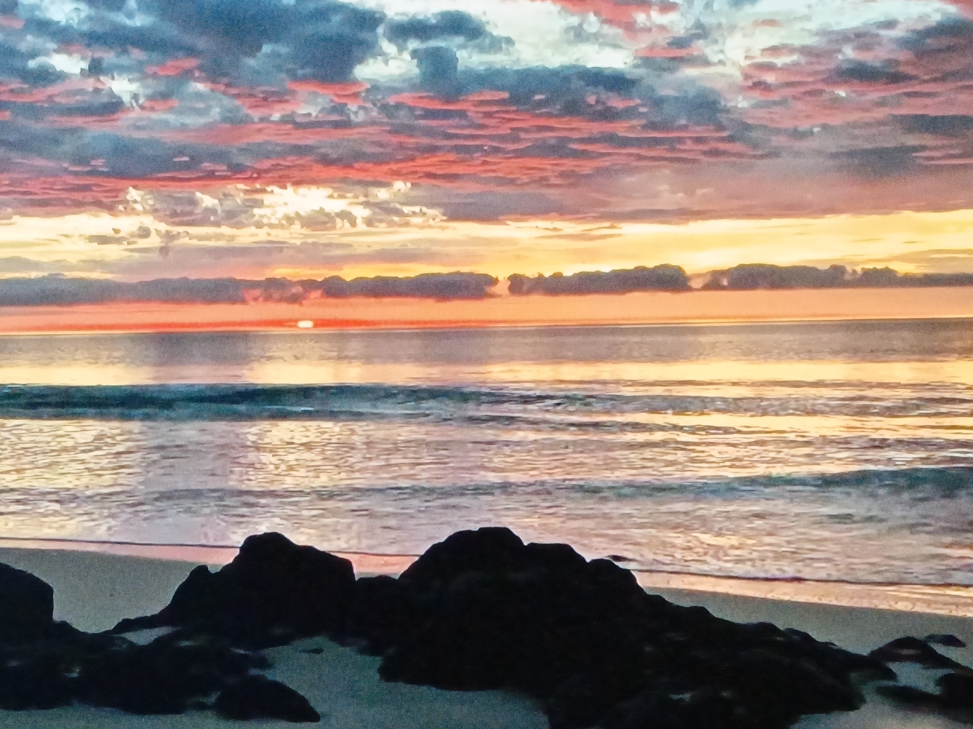 Colorful sunrise observed at Venezuelan beach near Juan Griego