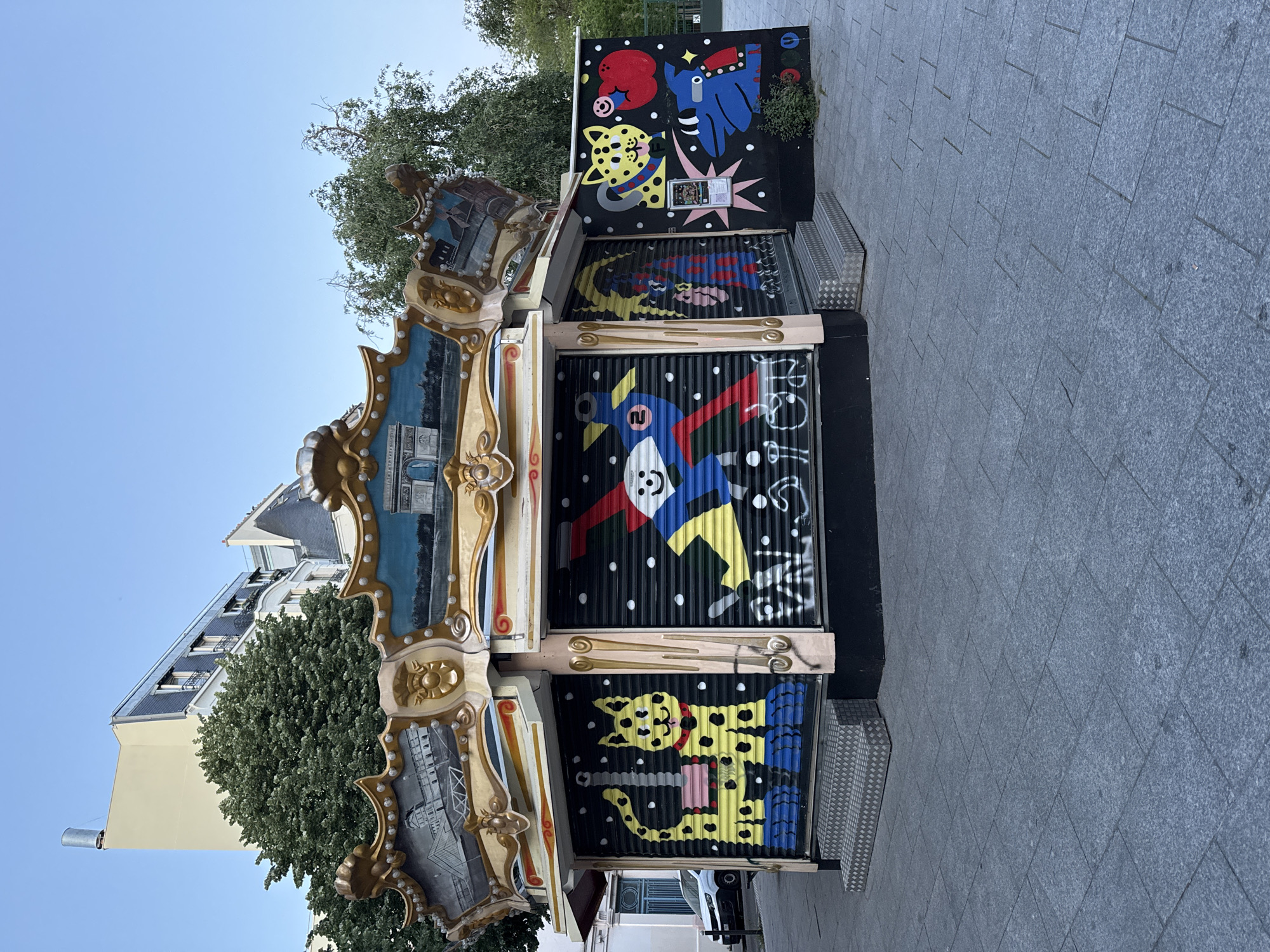 Evening street scenes documented around colorful Parisian kiosk