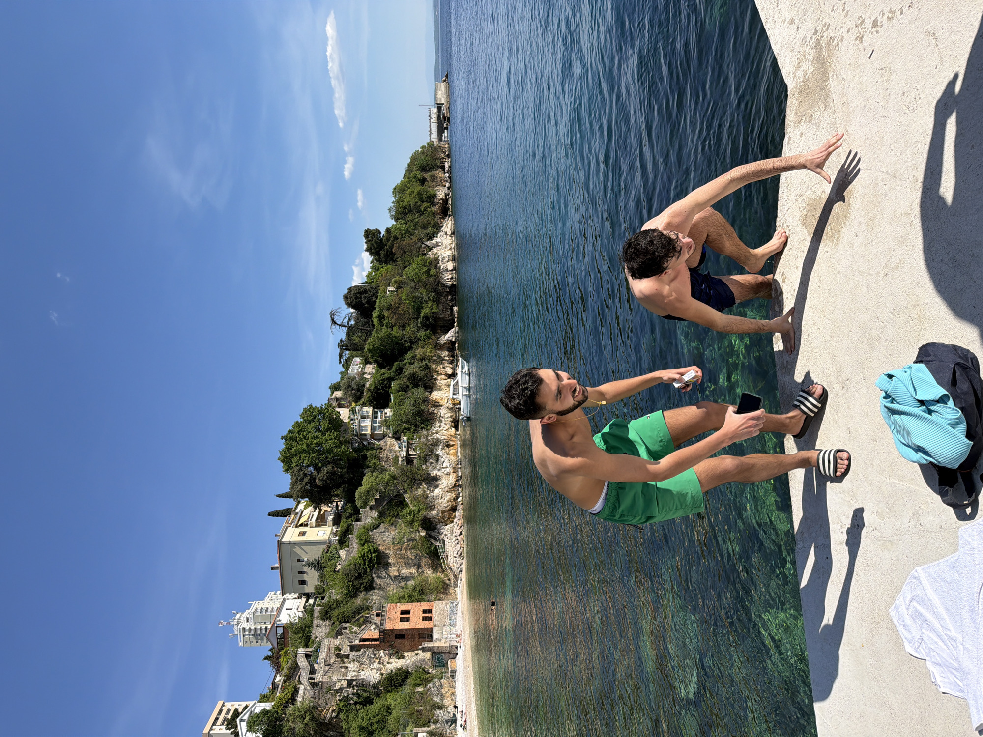 Two men relax on pier in sunny Rijeka