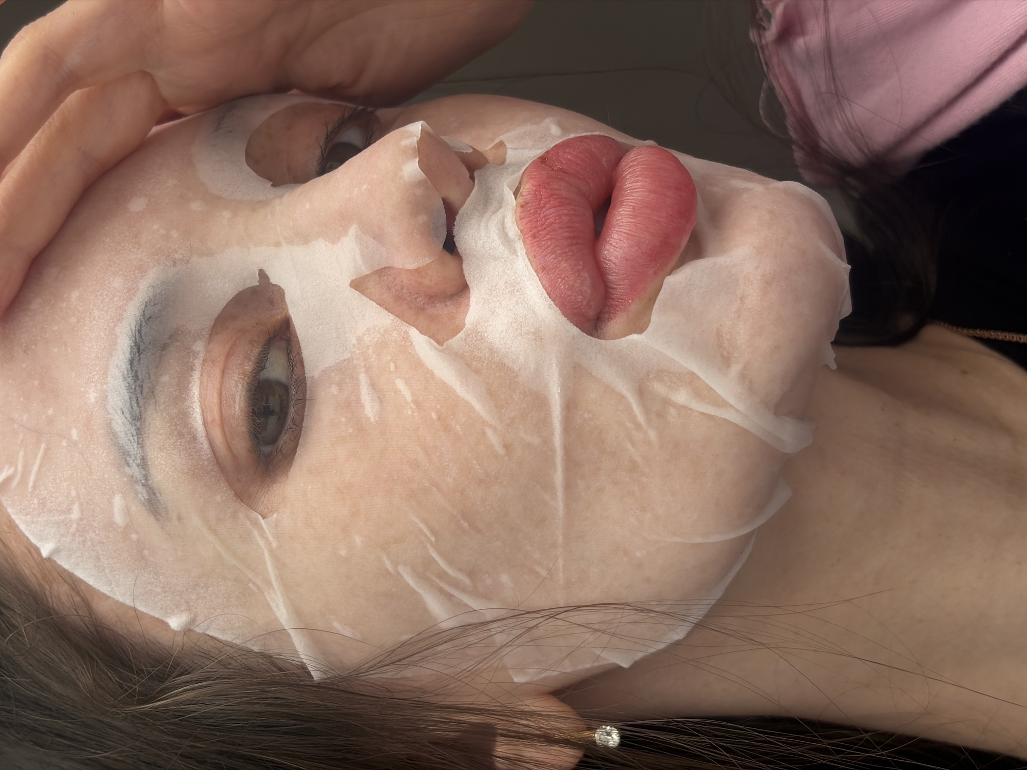 Person documents skincare routine with facial mask in Saint Petersburg