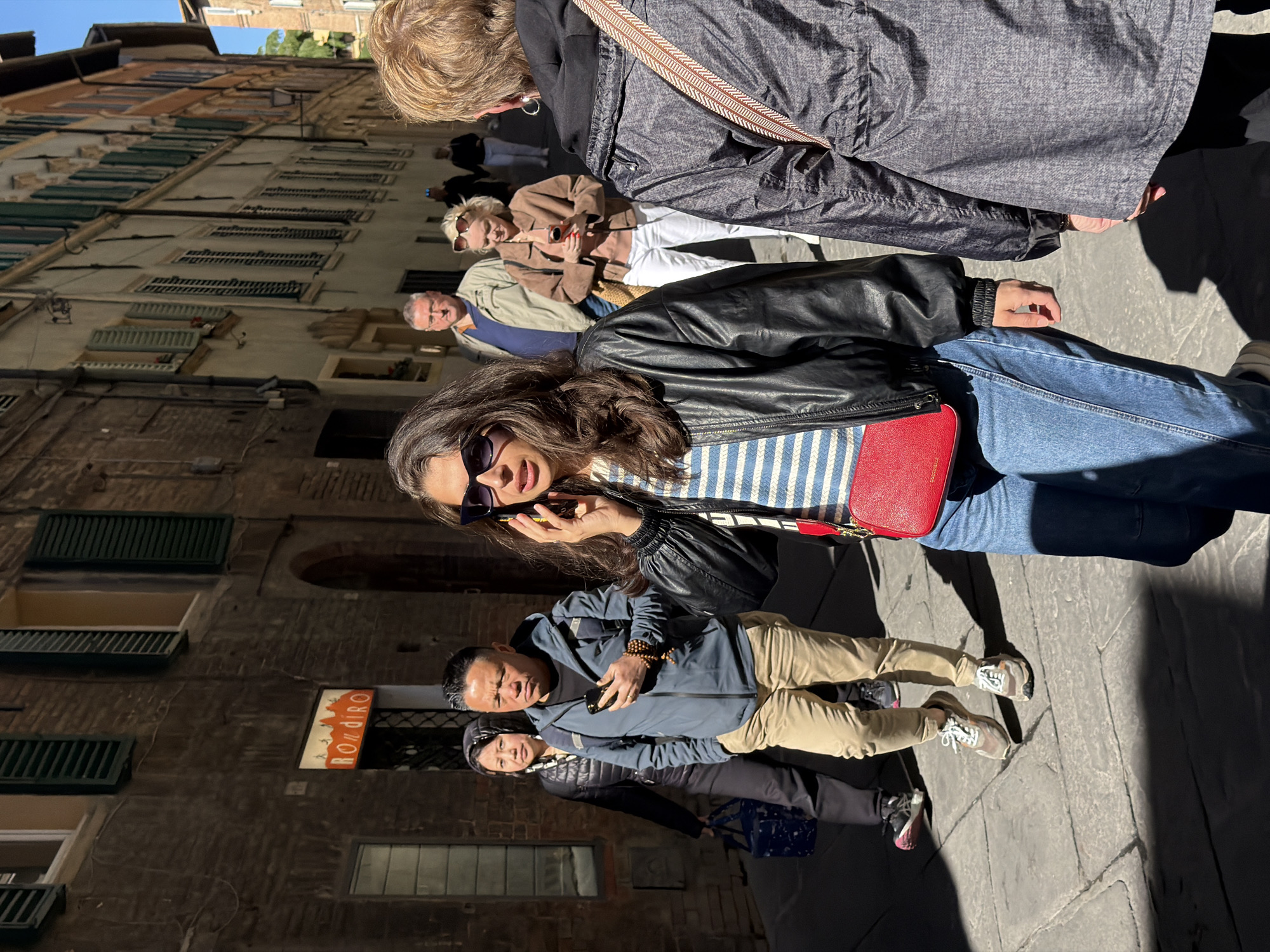Morning tourist activity captured in historic Siena streets