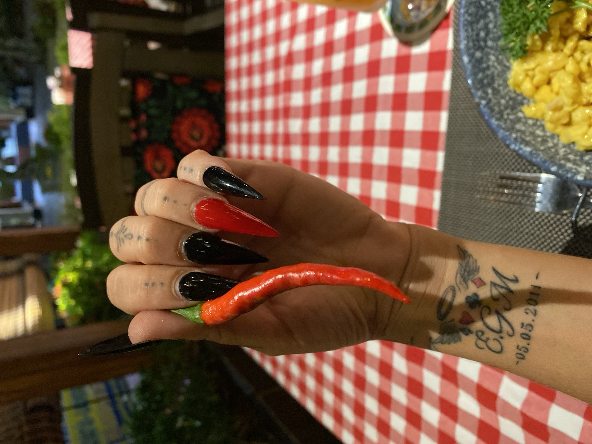 Tattooed diner enjoys meal with chili pepper in Vietnam