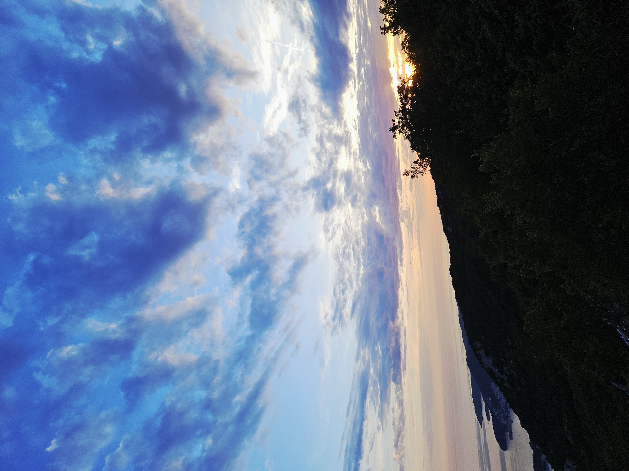 Sunset gathering at coastal overlook features tea, coffee, photography