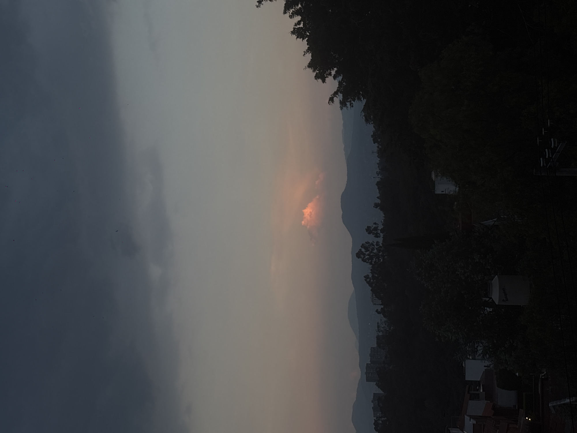 Dusk skyline captured over Mexico City showing distant hills