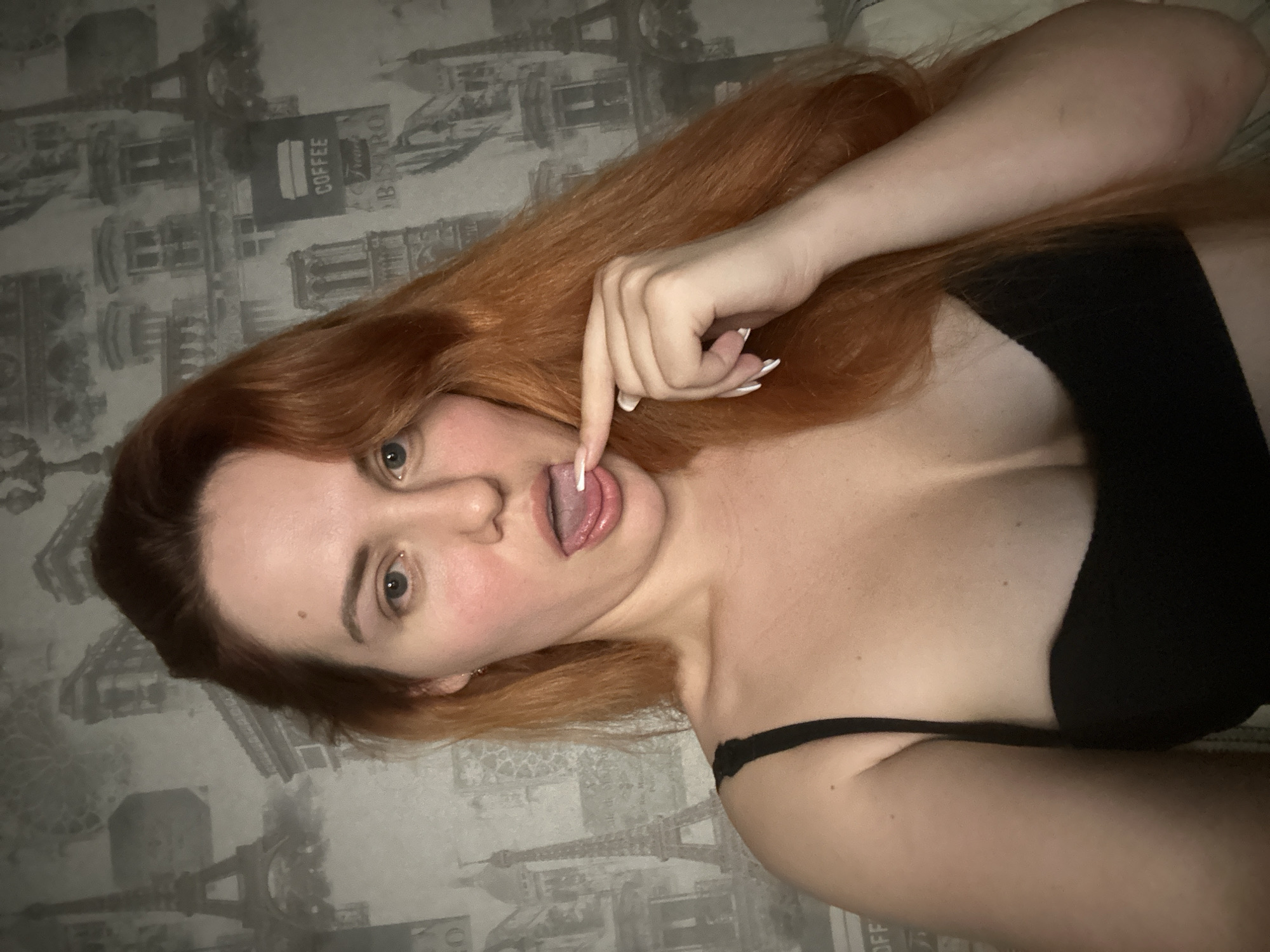 Indoor selfie session with Parisian wallpaper backdrop and orange cat