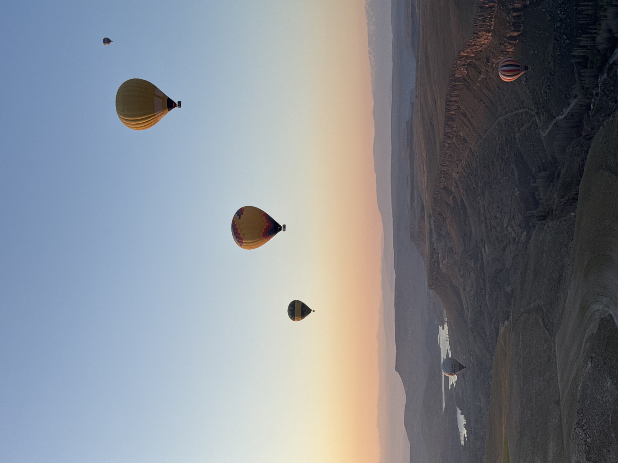Hot air balloons soar over Yeşilhisar at sunrise