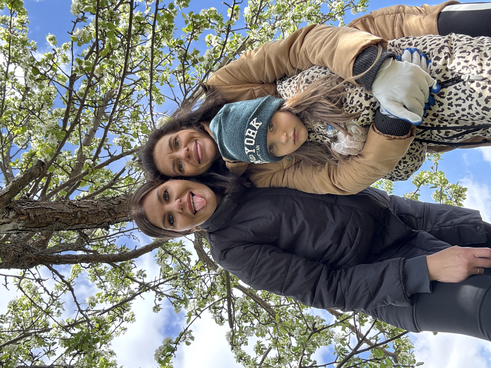Spring portrait session captured near blooming tree in Dubovaya