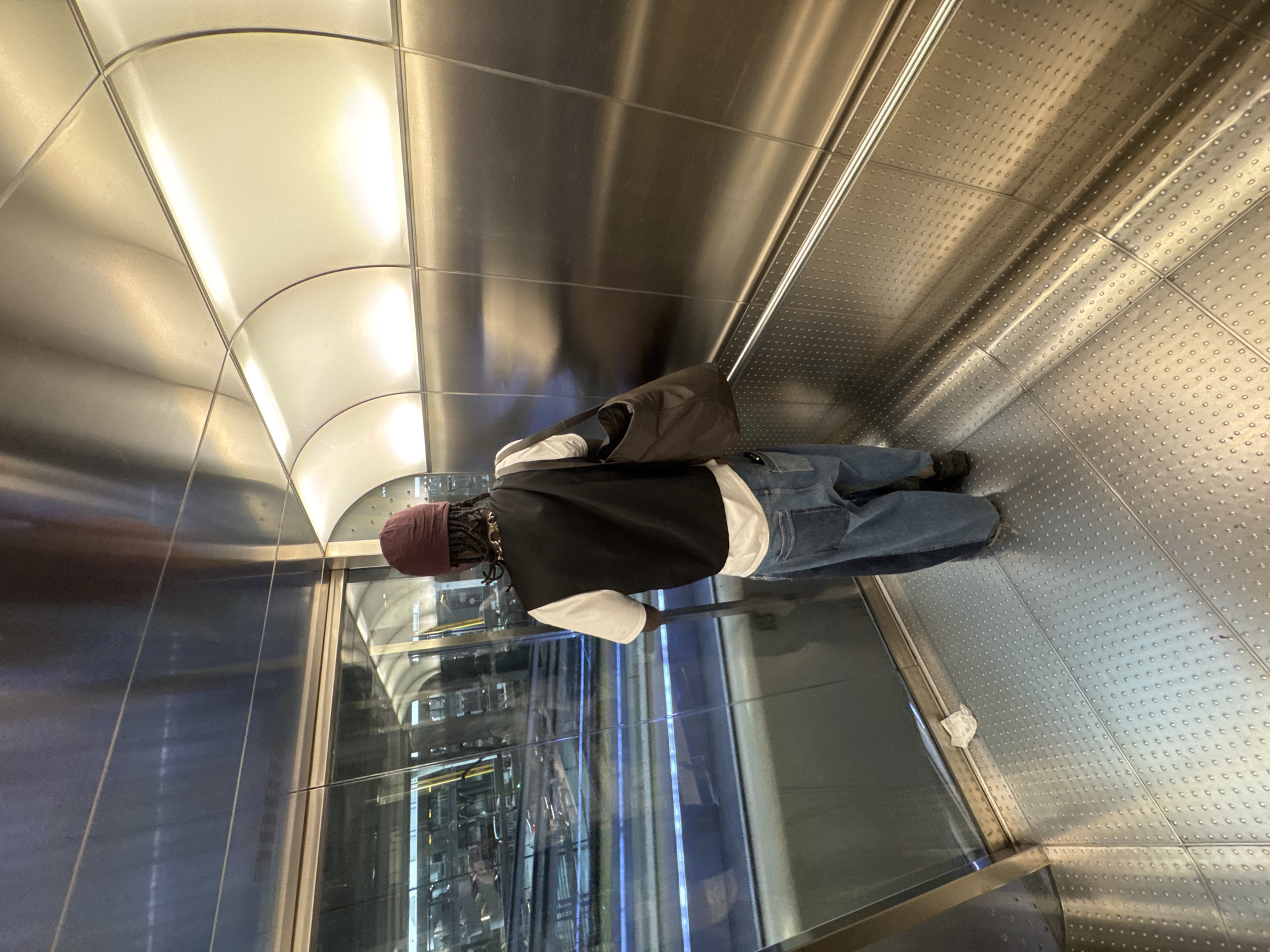 Man stands in metallic transit tunnel in Madrid