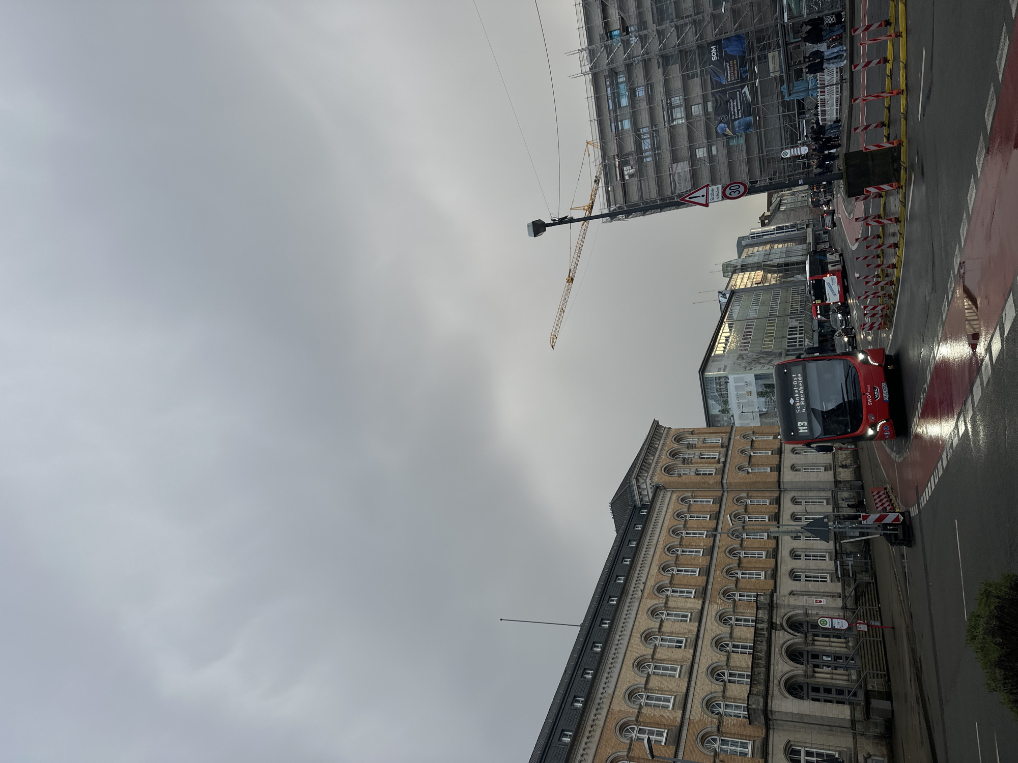 Double-decker bus navigates Osnabrück intersection during afternoon service