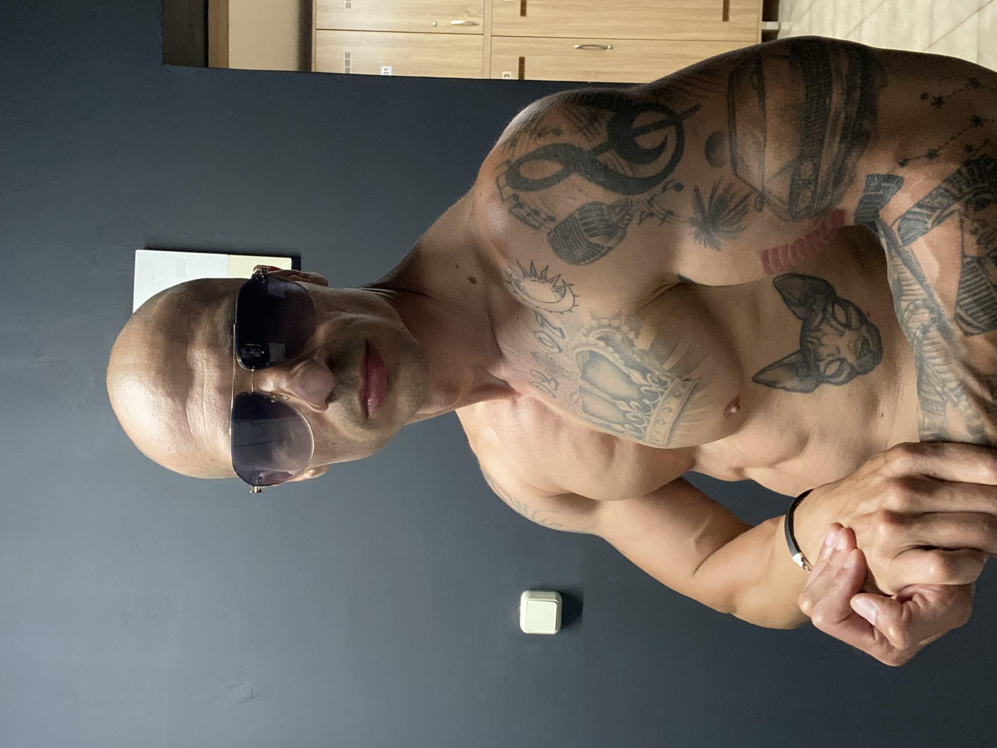 Tattooed man poses in gym locker room in Bulgaria