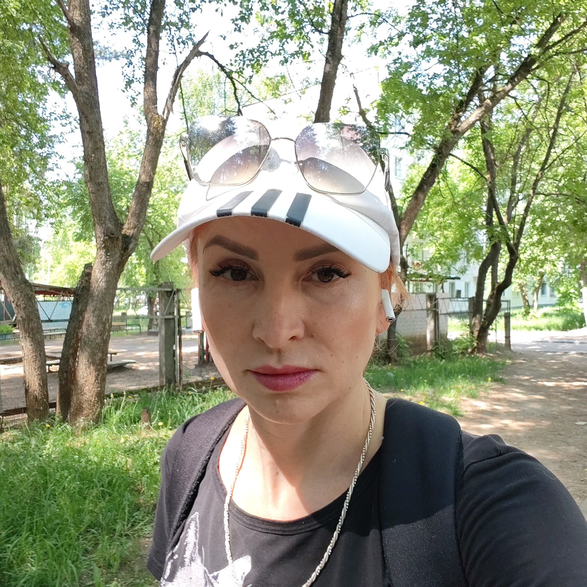 Woman takes selfies in garage and forest in Chaikovsky