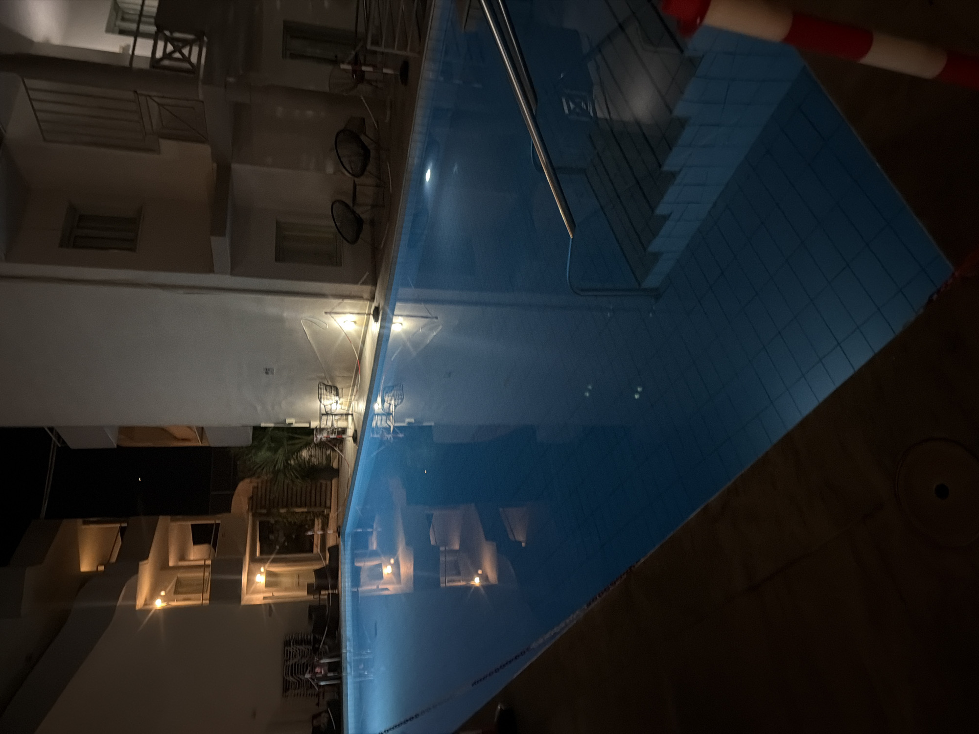 Lit outdoor pool at a Georgioupoli complex after dark