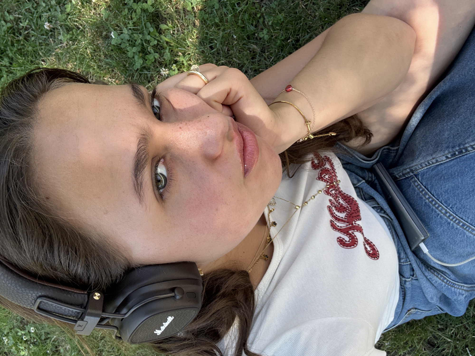 Woman relaxes with headphones in Milan park