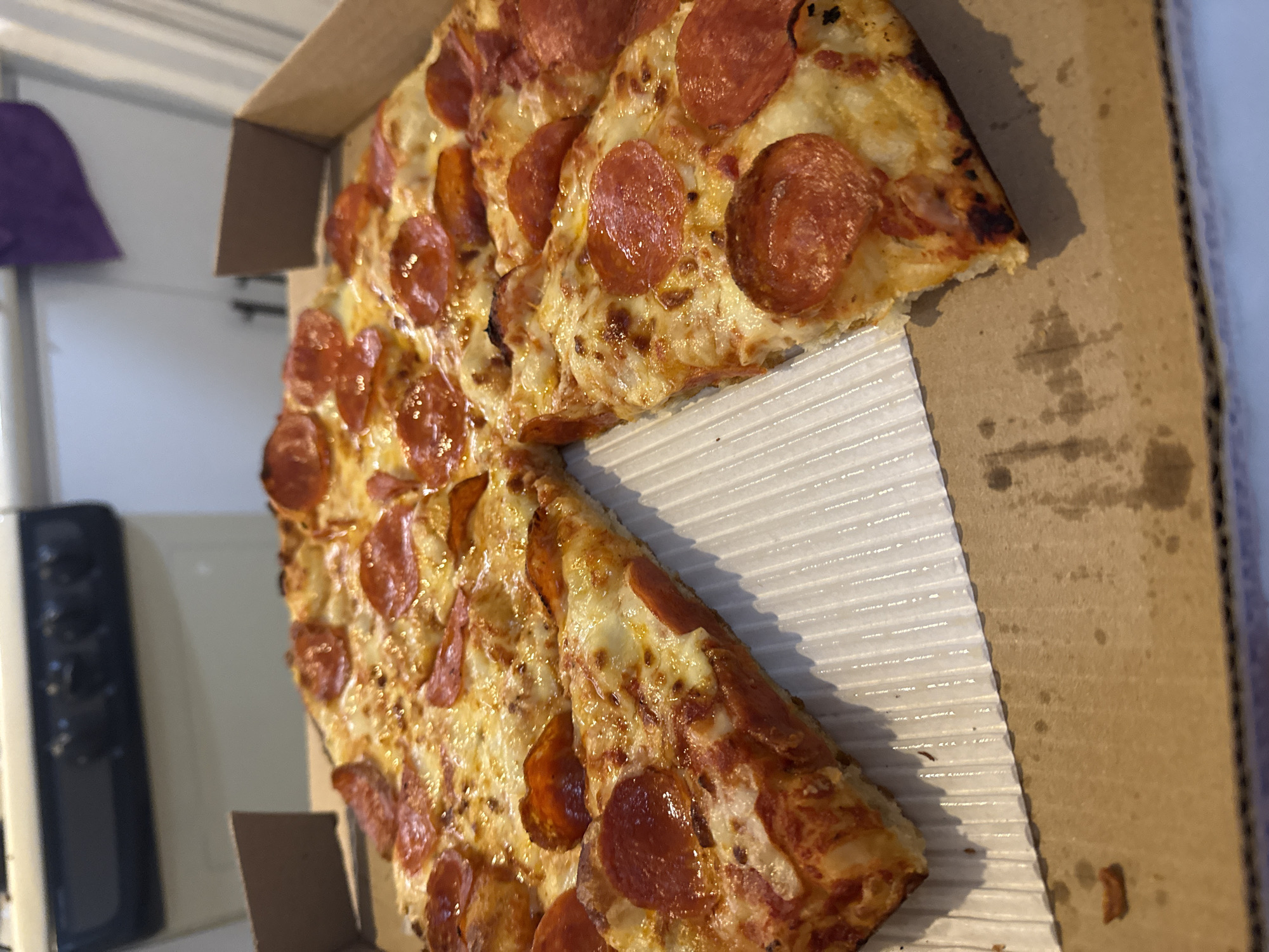Half-eaten pepperoni pizza documented in Puebla early morning