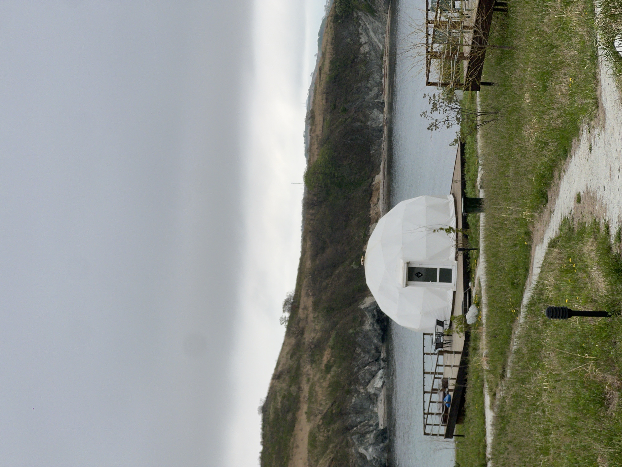 Person approaches waterfront dome structures in Zarubino, Russia