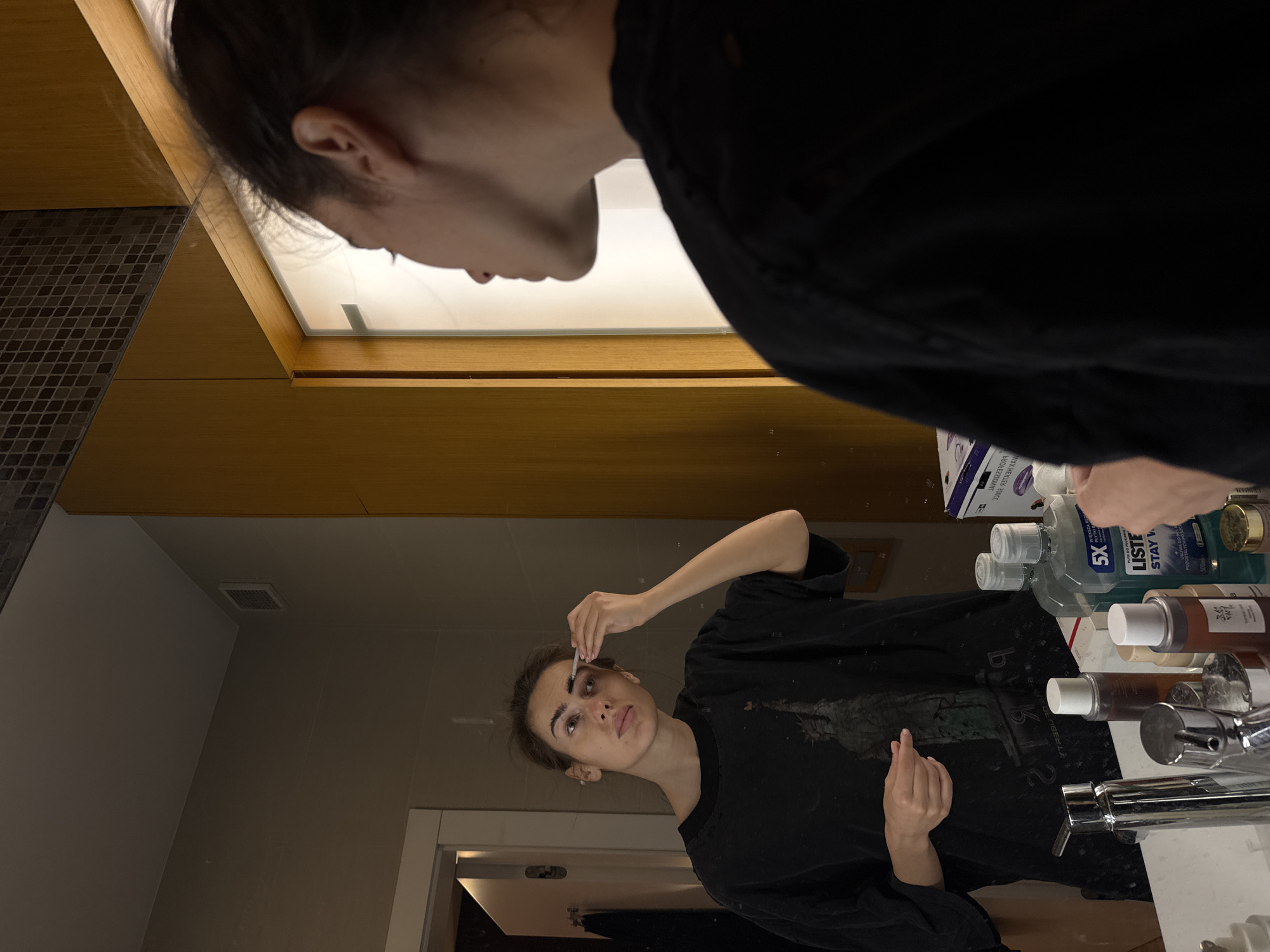 Woman conducts routine household activities in kitchen and bathroom