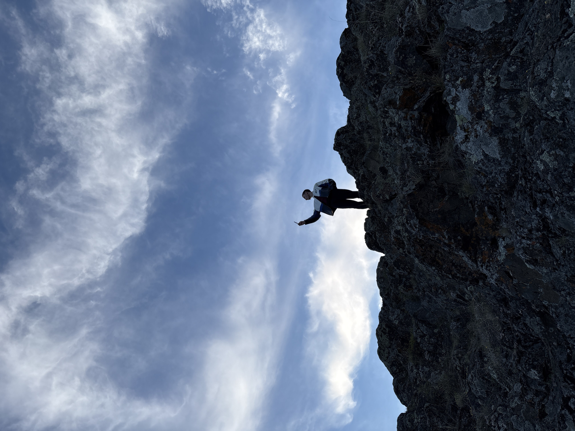 Person spends time contemplating at cliff edge near Невон