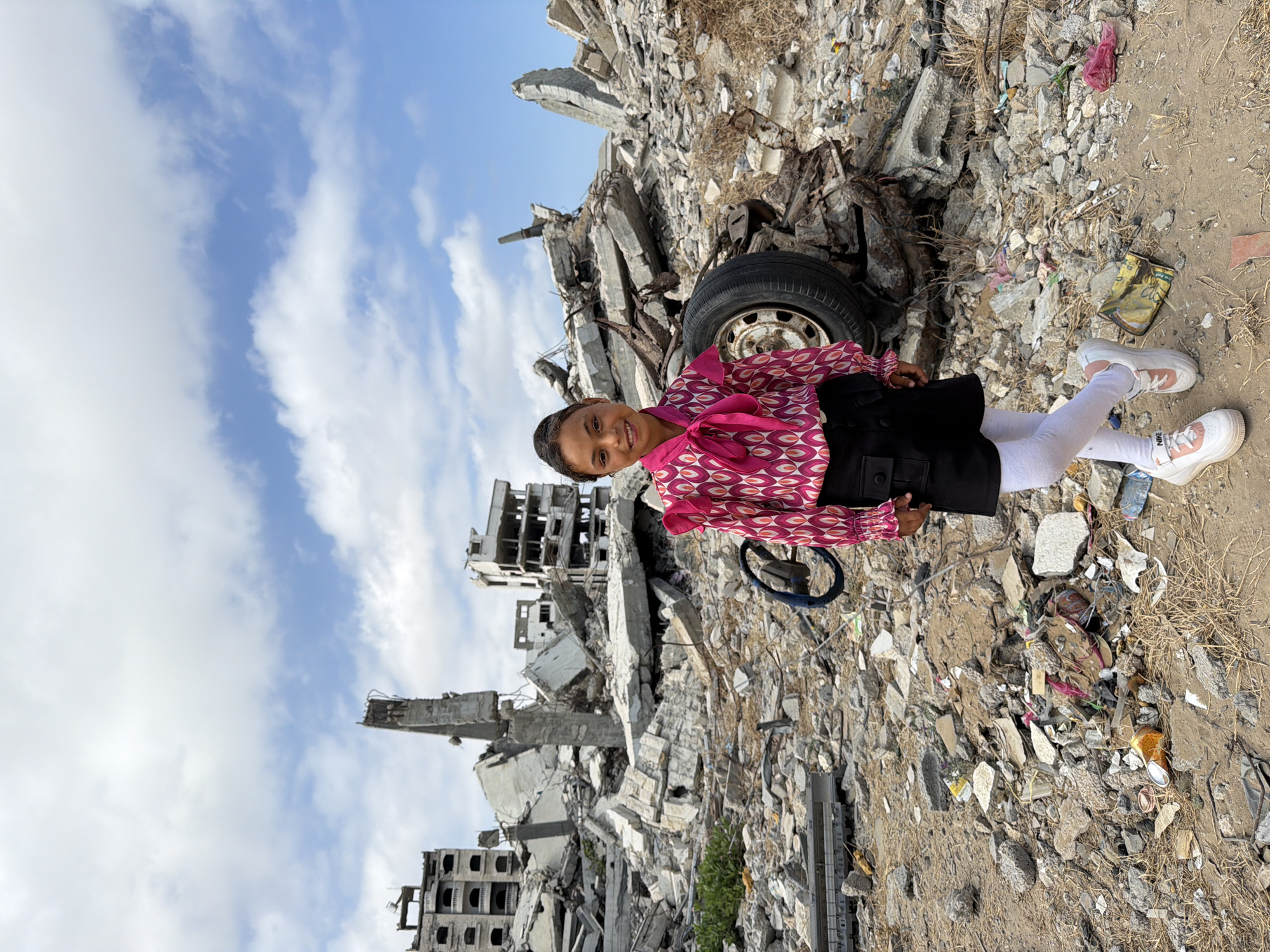 Girl and man witnessed among building rubble in Gaza City