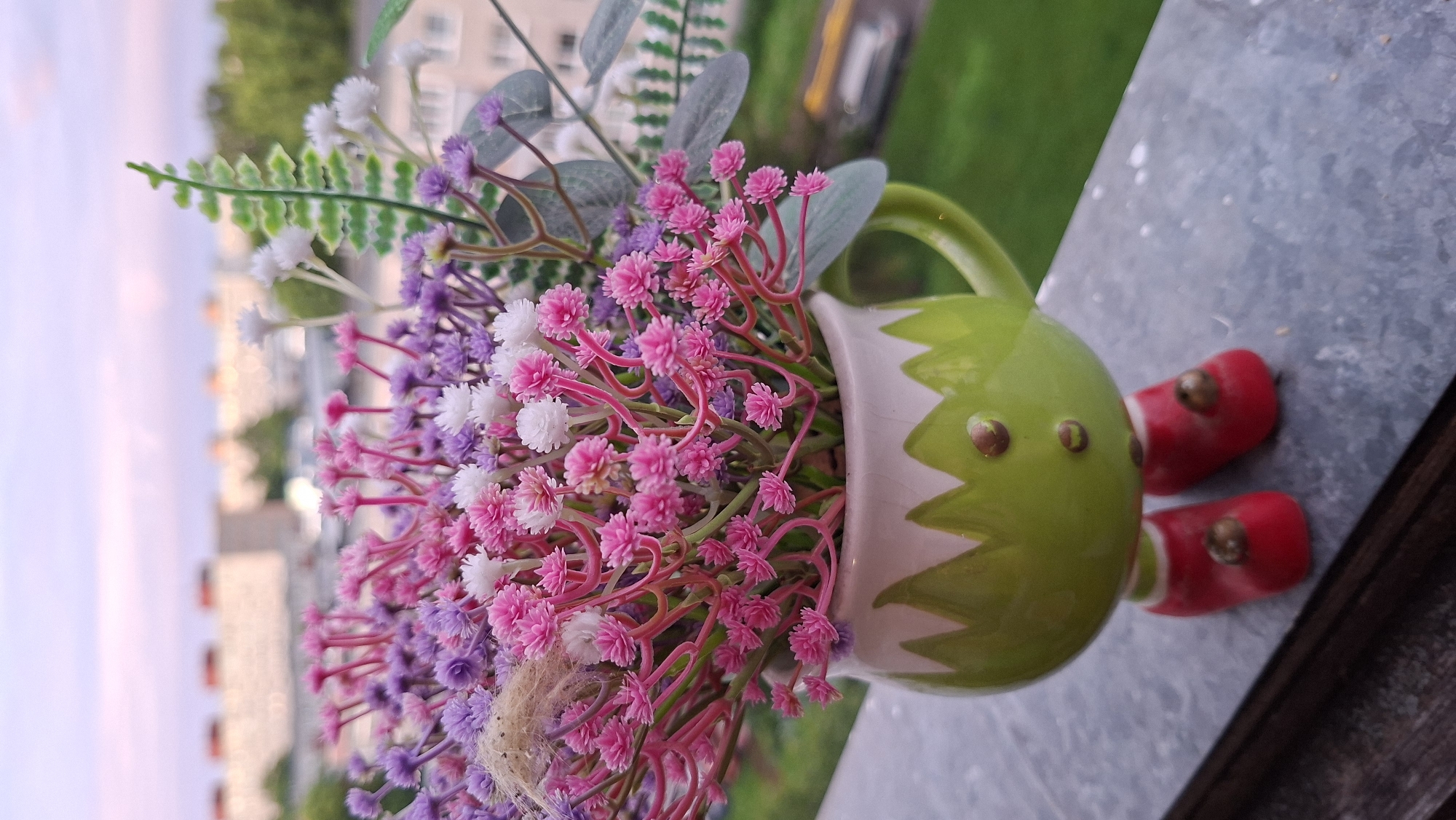 Tallinn evening: pastel skies, bokeh blooms, and a charming ceramic figurine
